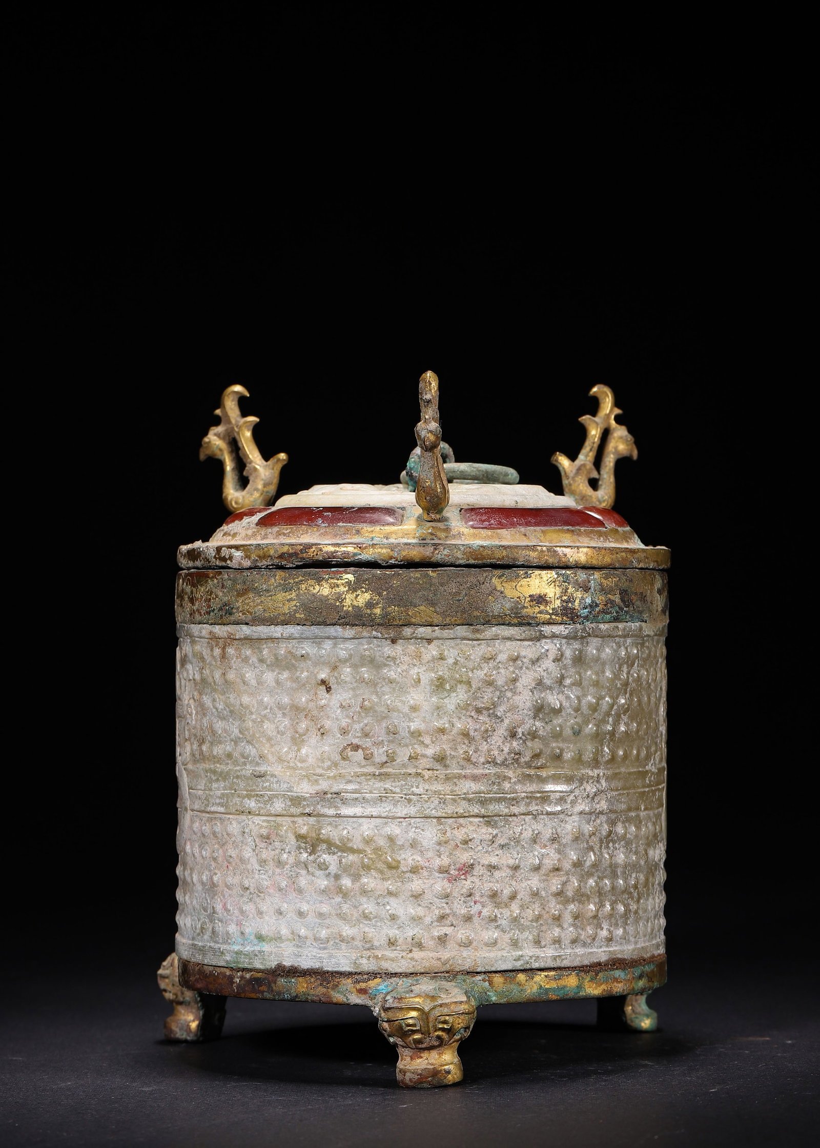 Celadon Jade Tripod Casket With Grain Pattern And Gilt Bronze Mounts, Han Dynasty (202 Bc 220 Ad): Wt 1454g (3.21 lb); D 10.5cm (4.13 in); H 14cm (5.51 in)The cylindrical body is carved from Hetian celadon jade fully decorated with grain pattern, featuring a relief beast head ring handle. The rim, 