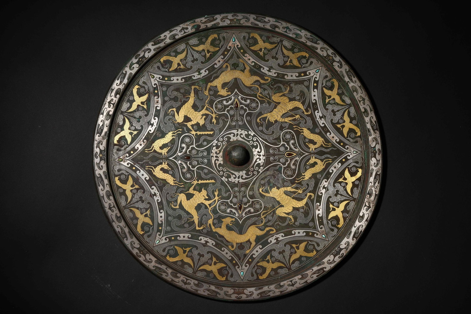 Han Dynasty Gold And Silver Inlaid Mythical Beast Pattern Bronze Mirror: Diameter 30.0cm (11.81in), Weight 2152.0g (4.74lb)c. 202 BCE 220 CE. Bronze Back with Cuo Jin & Silver Auspicious Beasts & Bird Patterns; Gold White Decorations Show Gorgeous Layers Against the Black 