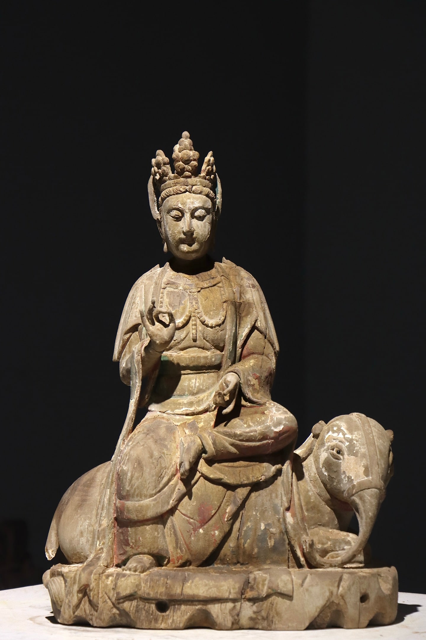 Painted Wooden Seated Statue Of Samantabhadra, Ming Dynasty (1368 1644): H 49cm (19.29 in); W 35cm (13.78 in)Wood core with original polychrome paint. Bodhisattva wears jewelled crown, seated cross legged on recumbent elephant. Right hand in teaching mudra, left hand holds