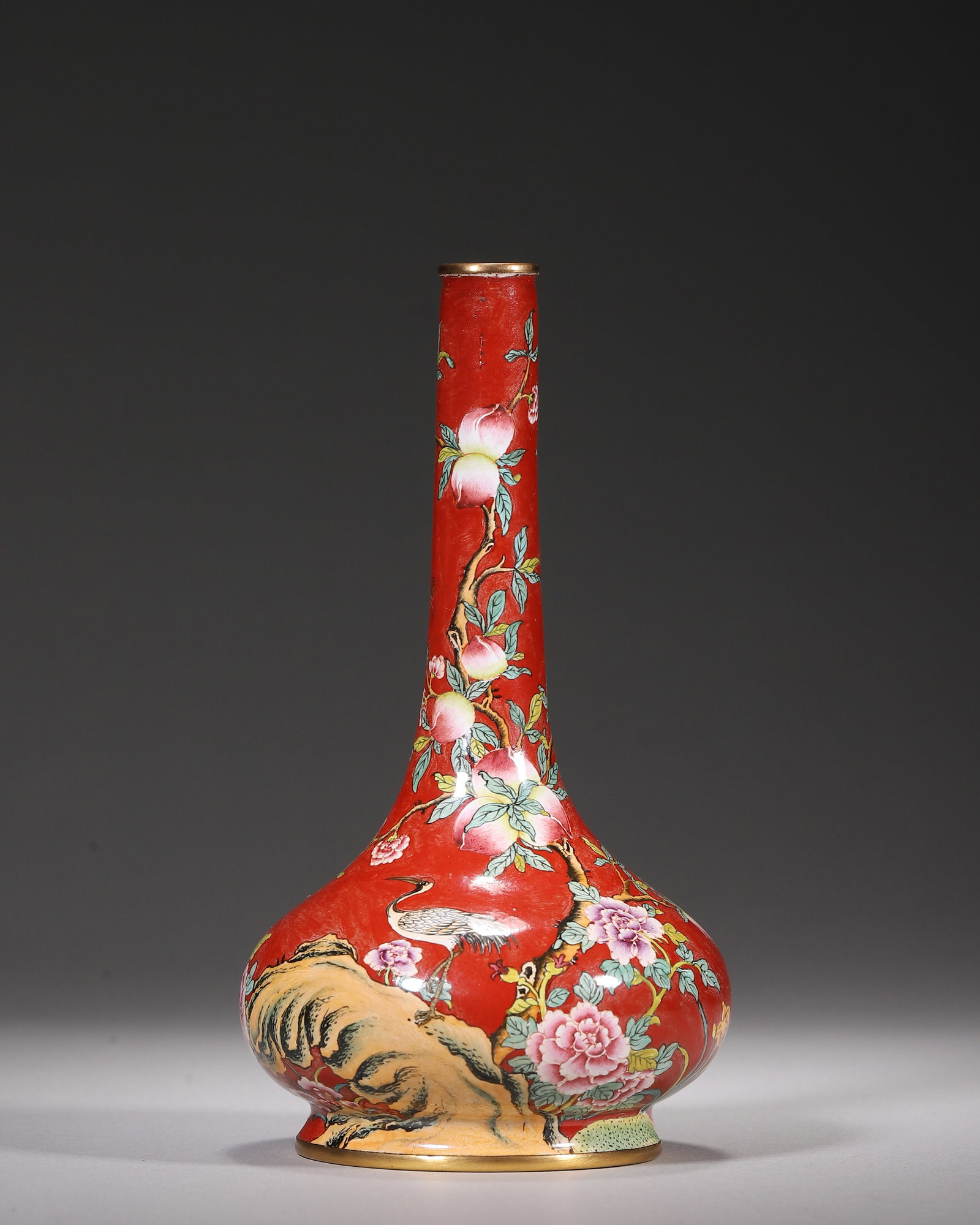 Copper Body Painted Enamel Long Necked Vase With Crane And Longevity Motifs, Qianlong Period, Qing: Wt 184g (0.41 lb); D 8cm (3.15 in); H 15cm (5.91 in)Gilded rim and foot on copper body. Red ground painted with cranes, peaches and peonies. Long necked form. Base bears blue enamel Qianlong mark.