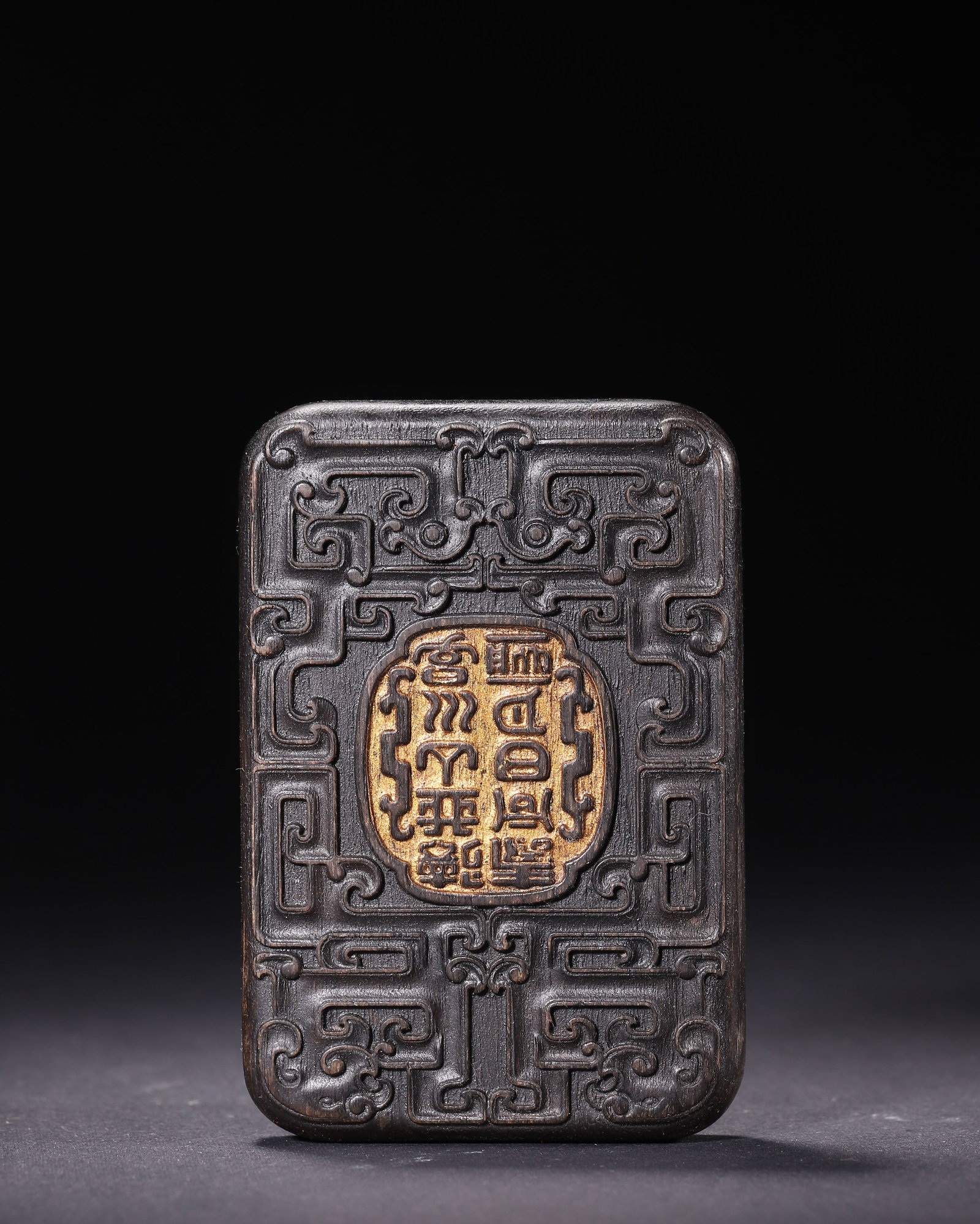 Agarwood Plaque With Gilt Kui Dragon Decoration Qing Dynasty: Wt 80g (0.18 lb); L 9cm (3.54 in); W 6.3cm (2.48 in)Agarwood plaque, relief carved kui dragon patterns, gilt seal characters in central panel. Rounded edges, drilled holes at base, rich patina.