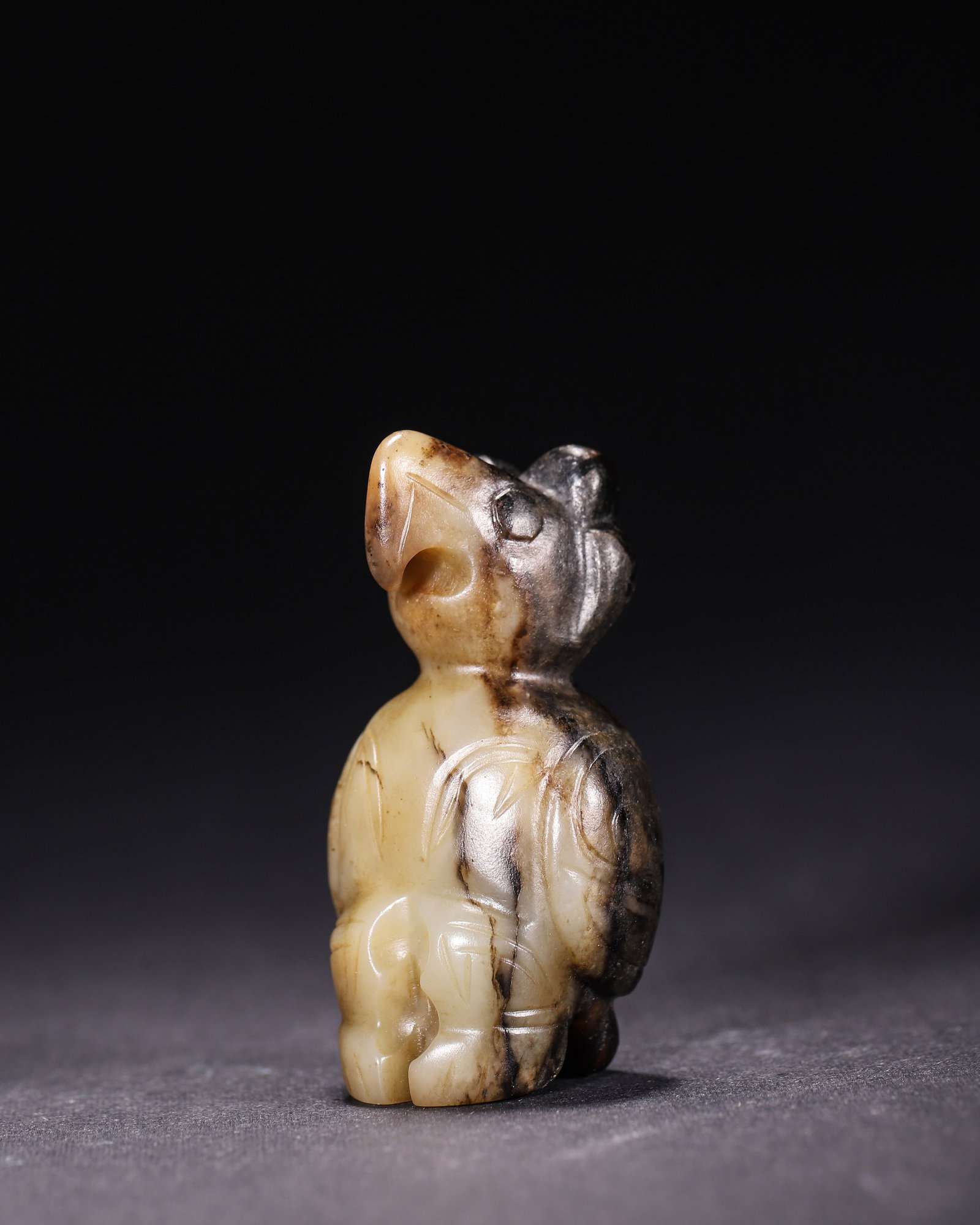 Hetian White Jade Owl Pendant With Black Grey Patina, Shang Dynasty: Wt 51g (0.11 lb); L 2.8cm (1.102 in); W 2.3cm (0.91 in); H 5.5cm (2.17 in)Carved from Hetian white jade with extensive black grey patina. The squatting owl has incised eyes and wings, hollowed on reve