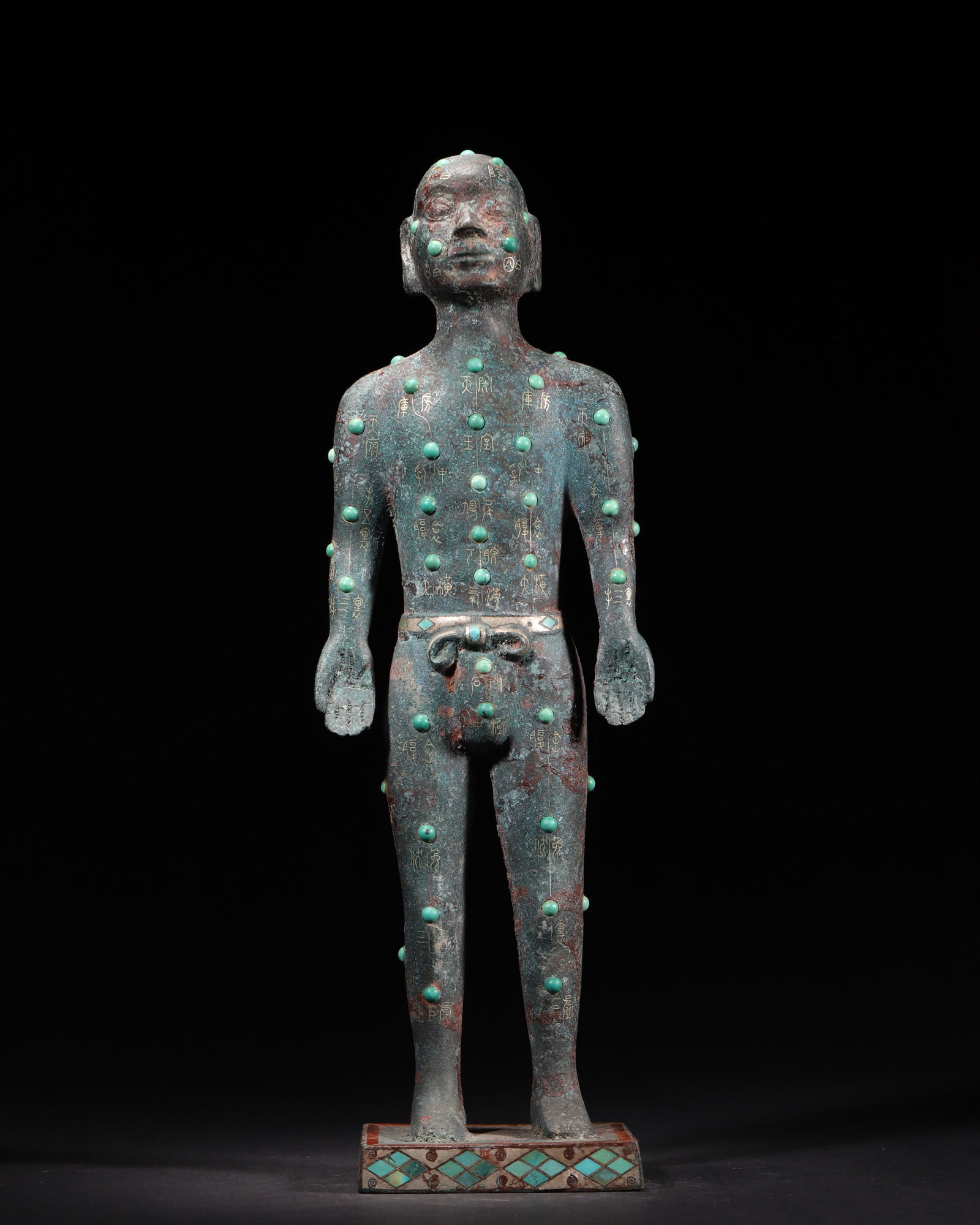 A Gold Inlaid Bronze Acupuncture Figure With Turquoise Inlays, Warring States Period: H 37.0cm (14.57 in); W 12.0cm (4.72 in); Wt 2828.0g (6.23 lb)A Warring States Period bronze acupuncture figure with gold inscriptions marking meridians and acupoints, inlaid with turquoise. It feature
