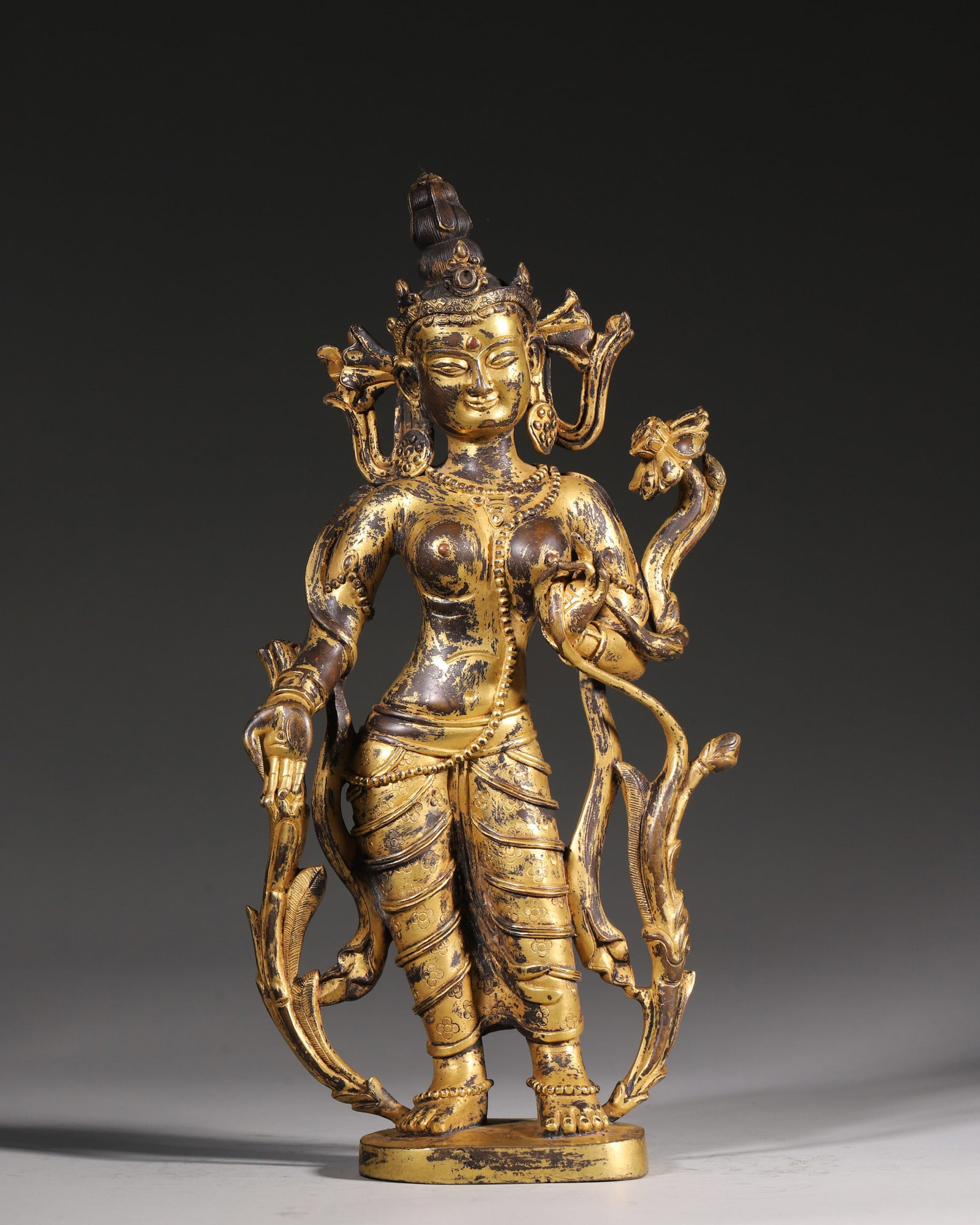 A Gilt Bronze Standing Statue Of Tara, Qing Dynasty: H 22cm (8.66 in); L 17cm (6.69 in); W 8cm (3.15 in); Wt 2563g (5.65 lb)This is a Qing Dynasty gilt bronze standing statue of Tara, the goddess of compassion in Tibetan Buddhism. Cast in fine bronze an