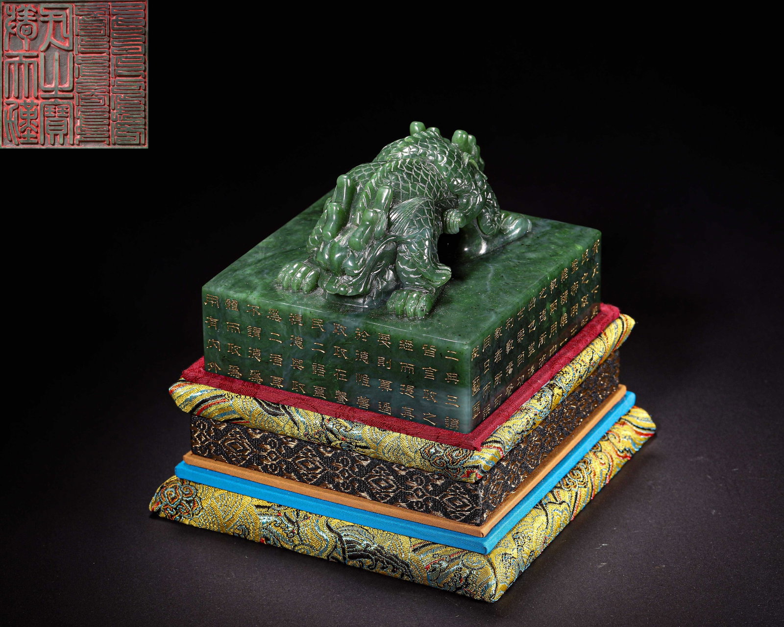Hetian Green Jade Dragon Handled Imperial Seal, Qing Dynasty, 1644 1912: Wt 2231g (4.92 lb); L 12cm (4.72 in); W 12cm (4.72 in); H 9cm (3.54 in)Hetian green jade imperial seal with intertwined dragon knob. Four sides carved with gilded imperial poems, seal face in nine fol