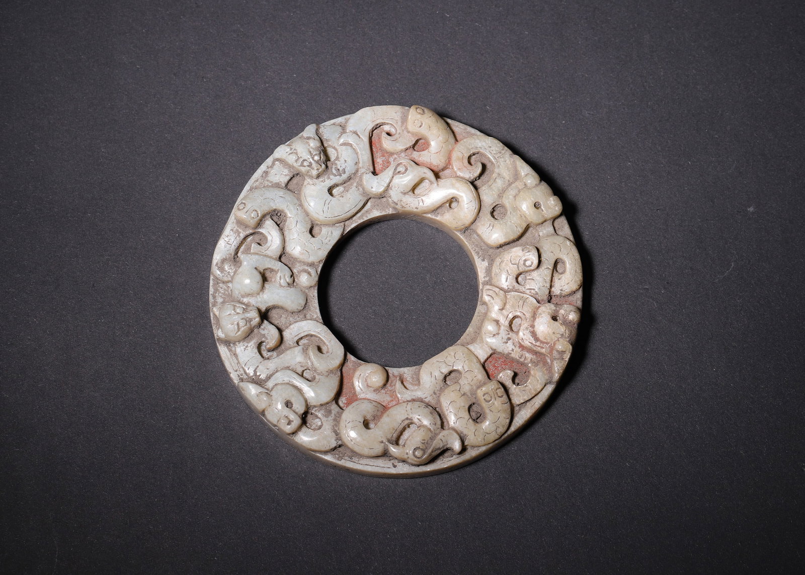 High Relief Hetian Jade Ring With Chilong And Granule Spirals, Han Dynasty (202 Bc 220 Ad): D 8.80cm (3.46 in); Wt 143.00g (0.32 lb)Carved from pale Hetian jade, wide band with large central aperture, decorated on both sides. Obverse carved with high relief intertwined chilong dragons with r