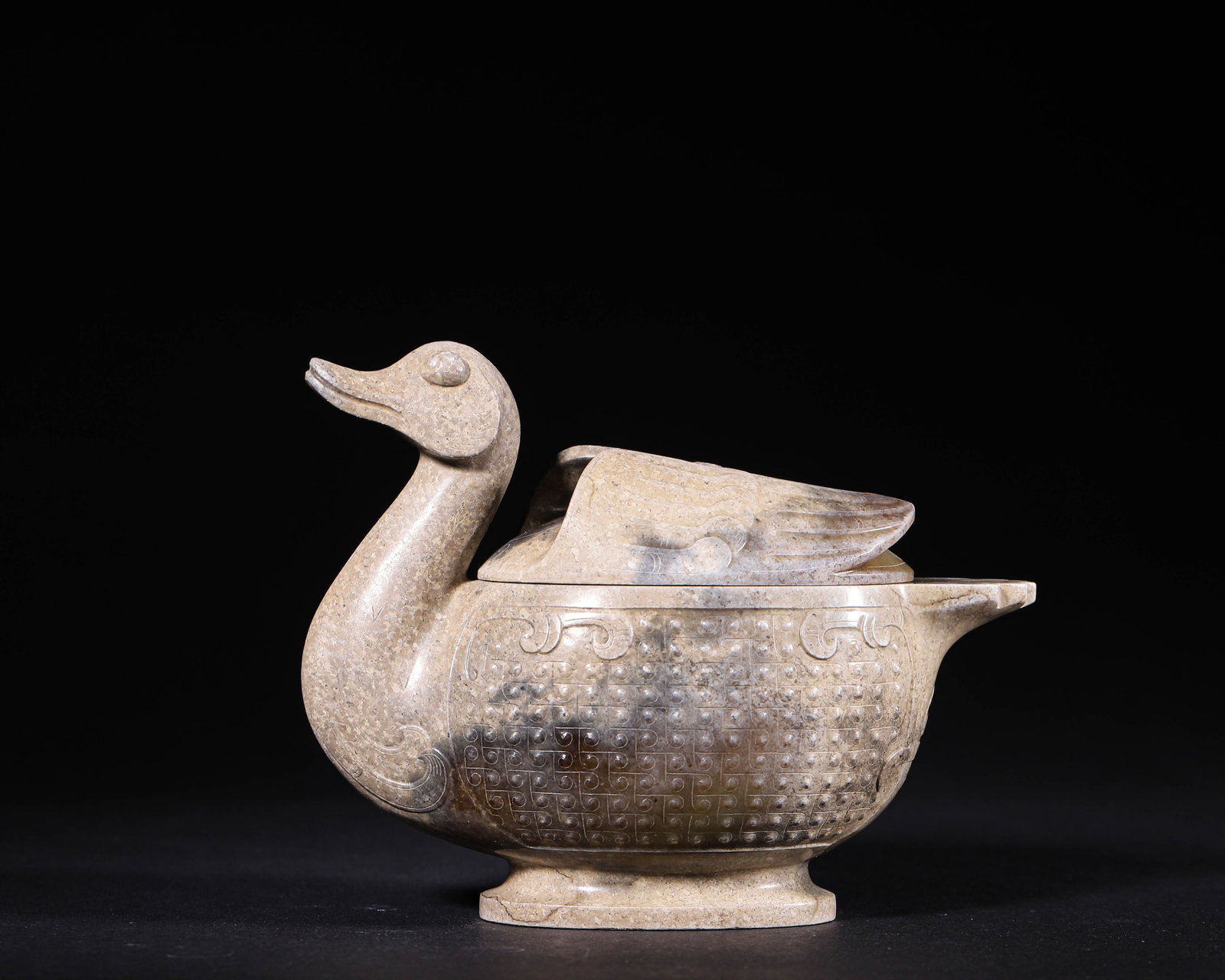Jade Goose Shaped Covered Vessel, Han Dynasty (202 Bc 220 Ad): Wt 458g (1.0097 lb); L 14cm (5.51 in); W 7cm (2.76 in); H 11cm (4.33 in)Fully carved jade goose shaped vessel with detachable wing form cover. Body decorated with grain and cloud patterns, spout on si