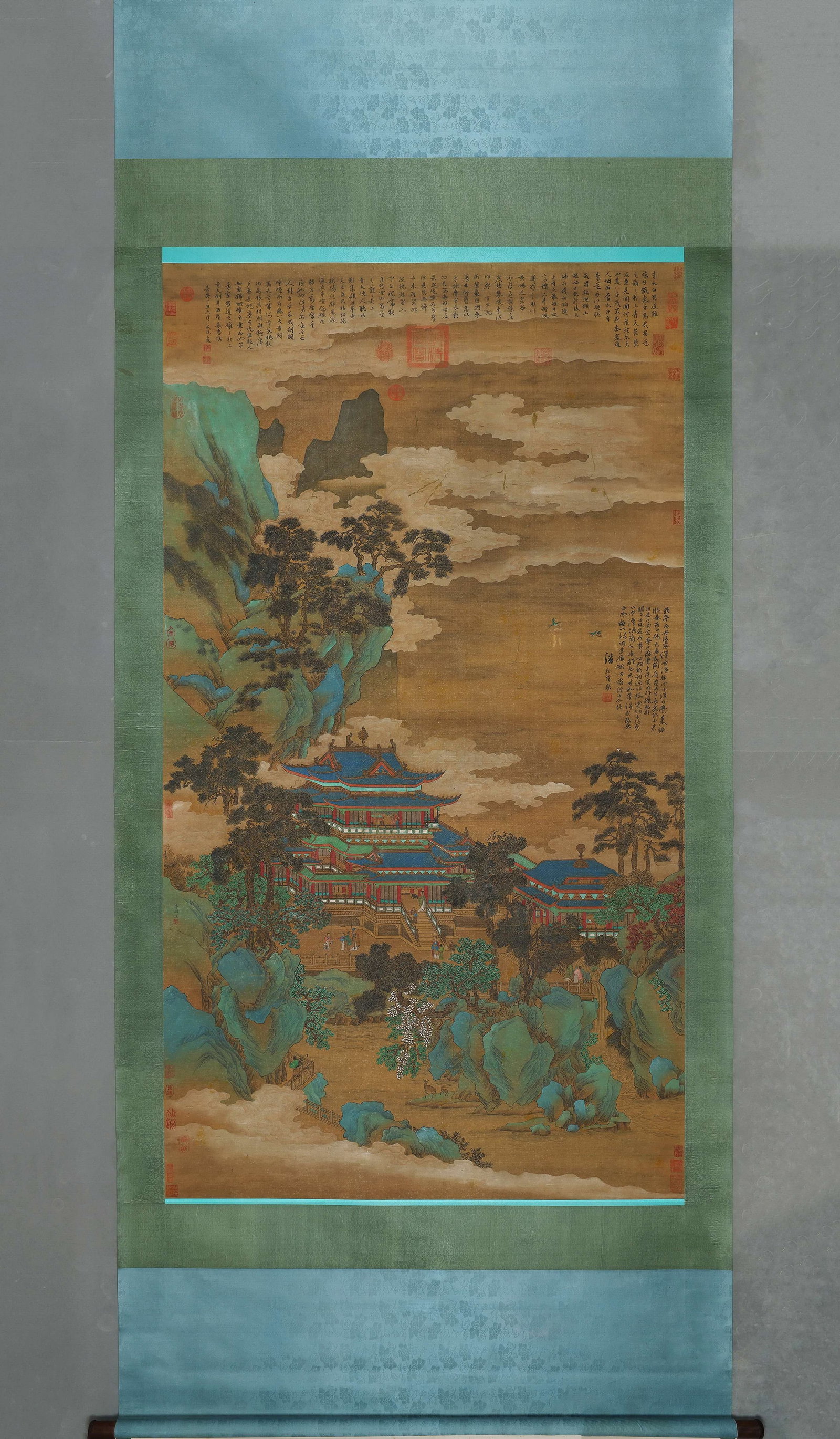 Hanging Scroll Of Immortal Pavilion Landscape By Li Zhaodao, Tang (618 907): Image L 182cm (71.65 in) Image W 104cm (40.94 in)Silk hanging scroll, heavy mineral green blue colours. Depicts cloud wrapped fairy mountains and ornate pavilions, dotted with figures. Full of histori