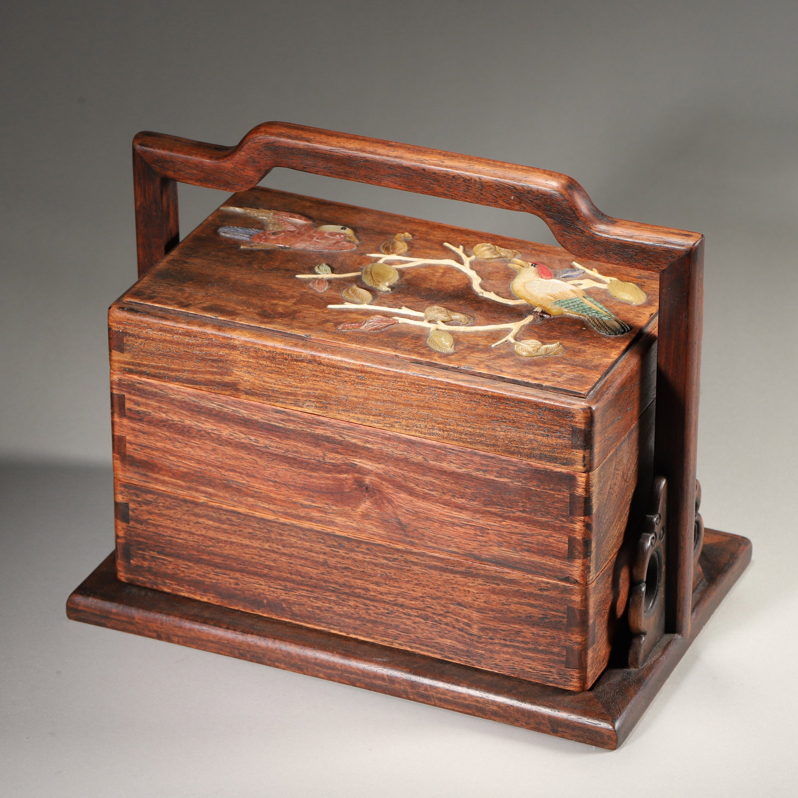 Huanghuali Tiered Handled Box With Precious Stone Inlay, Qing Dynasty (1636 1912): Wt 1079g (2.379 lb); L 23cm (9.055 in); W 15cm (5.906 in); H 18cm (7.087 in)Huanghuali wood two tier box with integrated handle. Lid inlaid with flower and bird motif. Distinct wood grain, neat tenon 