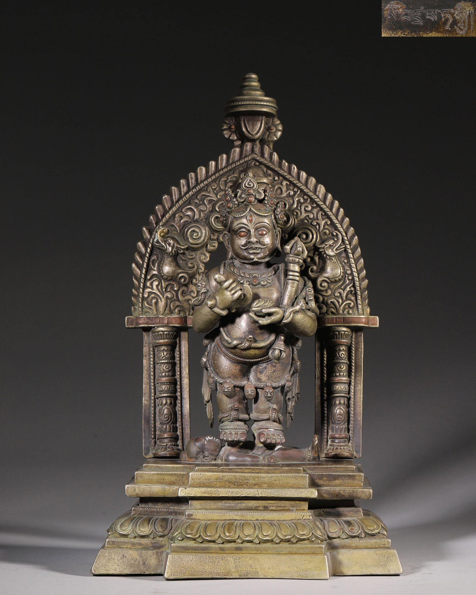An Alloy Copper Statue Of Black Jambhala, Qing Dynasty: H 32cm (12.6 in); L 20cm (7.87 in); W 13.5cm (5.31 in); Wt 4502g (9.93 lb)This is a Qing Dynasty alloy copper statue of Black Jambhala, the wealth deity in Tibetan Buddhism. Cast in alloy copper with 