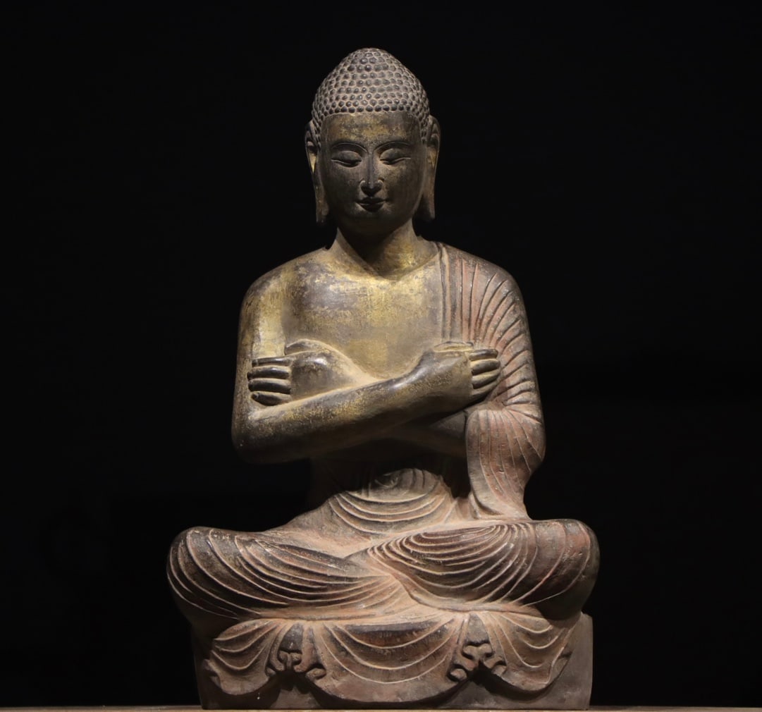 Gilded Bluestone Seated Sakyamuni Buddha, Northern Wei Dynasty (386 534): H 60cm (23.62 in); L 38cm (14.96 in); W 22cm (8.66 in)Bluestone figure with residual gilding and pigment. The Buddha has snail shell hair and serene countenance, arms crossed on chest, seated in lotus