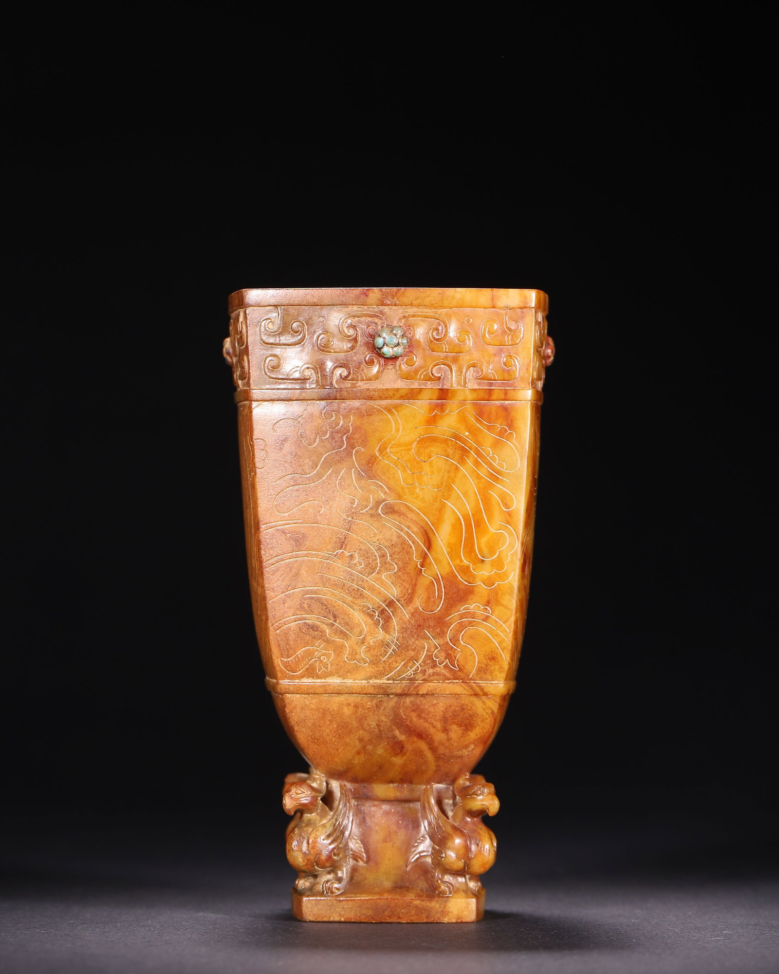 Hetian Jade Square Cup With Inlaid Gems And Phoenix Feet, Han Dynasty (202 Bce 220 Ce): Wt 499g (1.1001 lb); L 7.5cm (2.95 in); W 7.5cm (2.95 in); H 14.5cm (5.71 in)Huang brown tinted Hetian jade square cup with inlaid gems. Body incised with dragon, phoenix and cloud patterns, supported