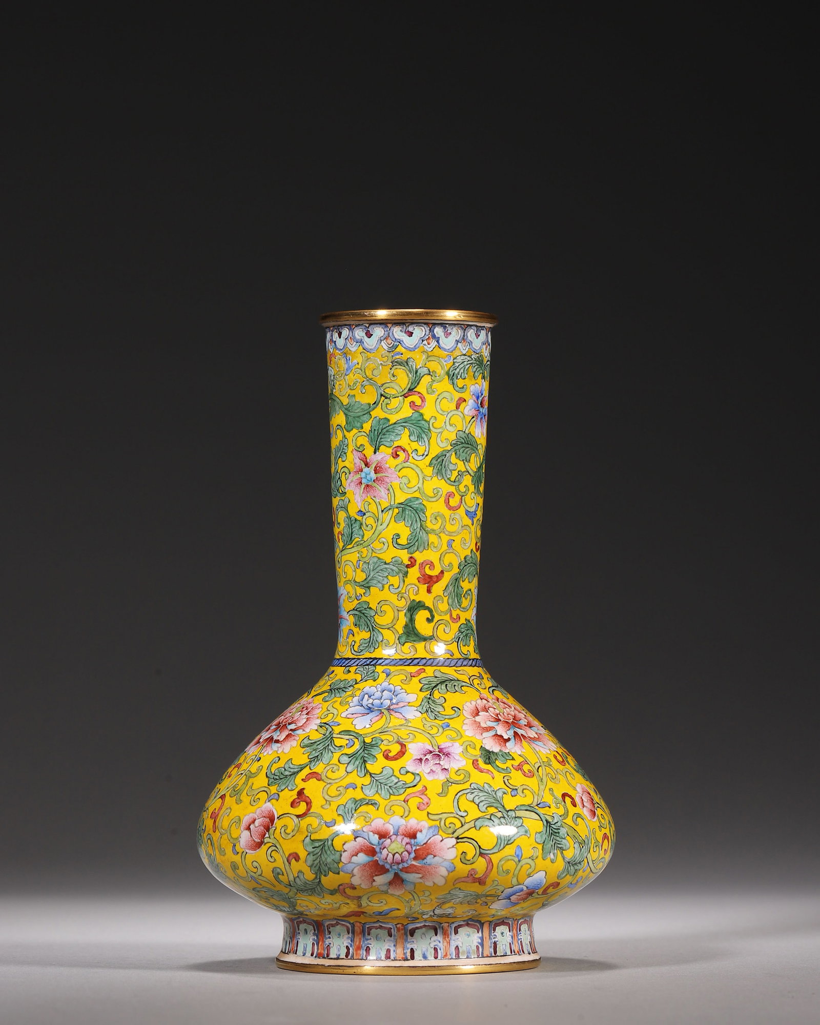 Copper Body Painted Enamel Bottle Vase With Yellow Ground Interlocking Peony Pattern, Qianlong: Wt 341g (0.75 lb); D 8cm (3.15 in); H 13cm (5.12 in)Gilt copper body water chestnut shaped vase. Straight neck and flattened bulbous belly. Bright yellow ground fully decorated with scrolling peonies.