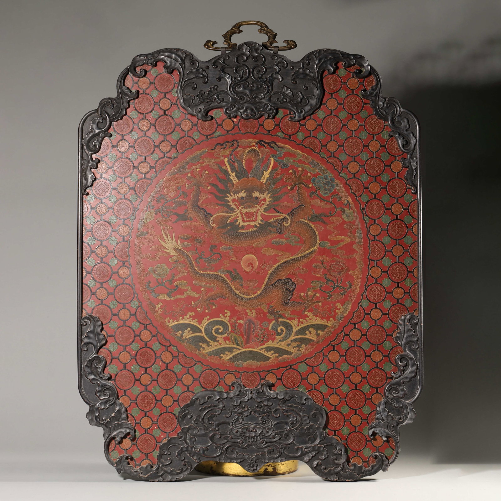 Carved And Filled Lacquer Hanging Panel With Dragon Motif, Qing Dynasty (1644 1912): Wt 4930g (10.869 lb); W 57cm (22.441 in); H 73cm (28.740 in)Red lacquer ground within carved zitan frame with brass hanger. Carved and filled lacquer depicts dragon chasing pearl amid waves and floral