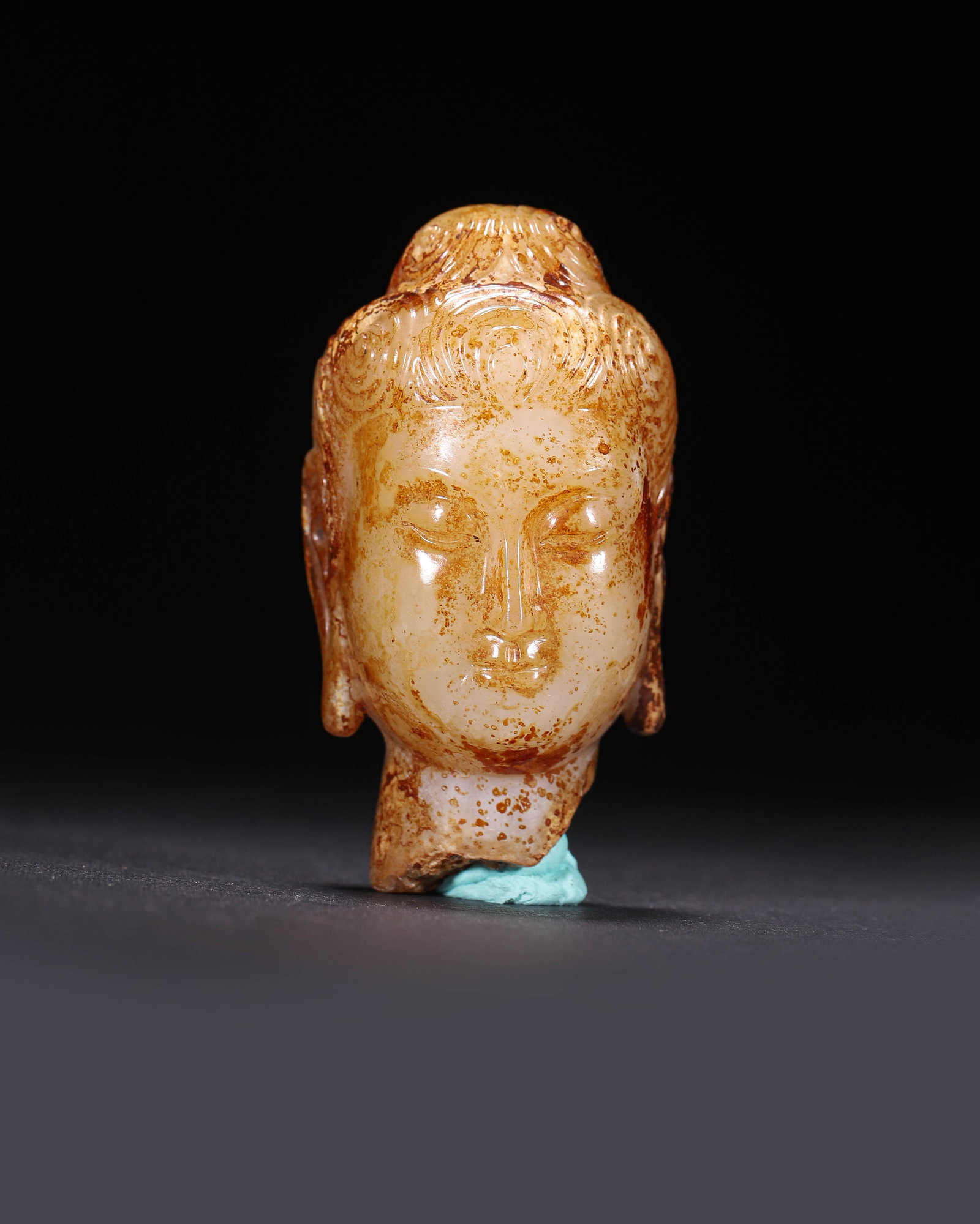Jade Bodhisattva Head,Tang Dynasty (618 Ad 907 Ad): Wt 85g (0.19 lb); L 3.5cm (1.38 in); W 2.5cm (0.98 in); H 6.5cm (2.56 in)White jade with reddish brown patina.High relief bodhisattva head features neat curly hair and gentle face.Its neck is broken,i