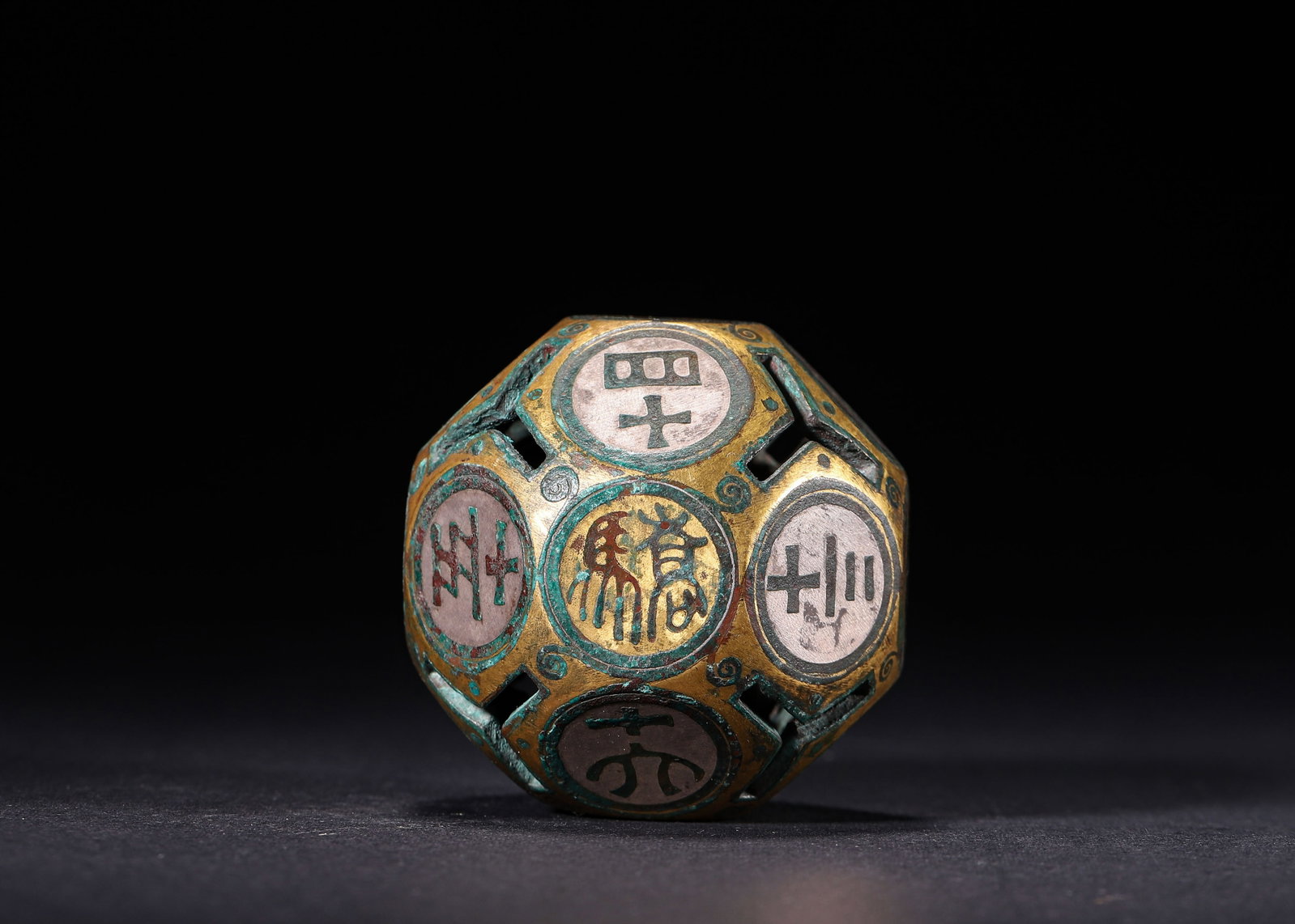 Gilt Bronze 18 Sided Drinking Game Die With Silver Inlay, Han Dynasty (202 Bc 220 Ad): Wt 142g (0.31 lb); W 5cm (1.97 in)An openwork gilt bronze 18 sided die for ancient drinking games. Each face is inlaid with silver archaic characters and symbols, embellished with spiral motifs. Beari