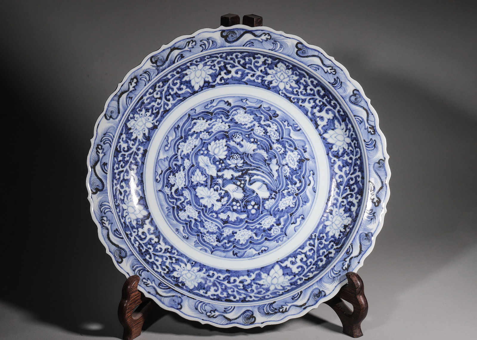 A Blue And White Foliate Rim Charger With Twin Cranes In Lotus Pond And Wave Motifs, Yuan Dynasty (1 of 8)