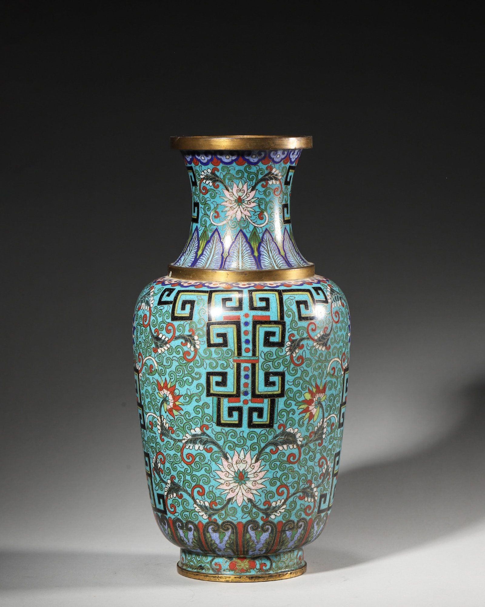 Gilt-Bronze Cloisonne Vase With Interlocking And Scrolling Lotus, Qing Dynasty: Vase with flared mouth, gilt rims and base, turquoise-ground cloisonne with interlocking patterns and scrolling lotus, inscribed Yu Ci Jing Lao on base, imperial presentation ware.D12cm (4.72 in); H26