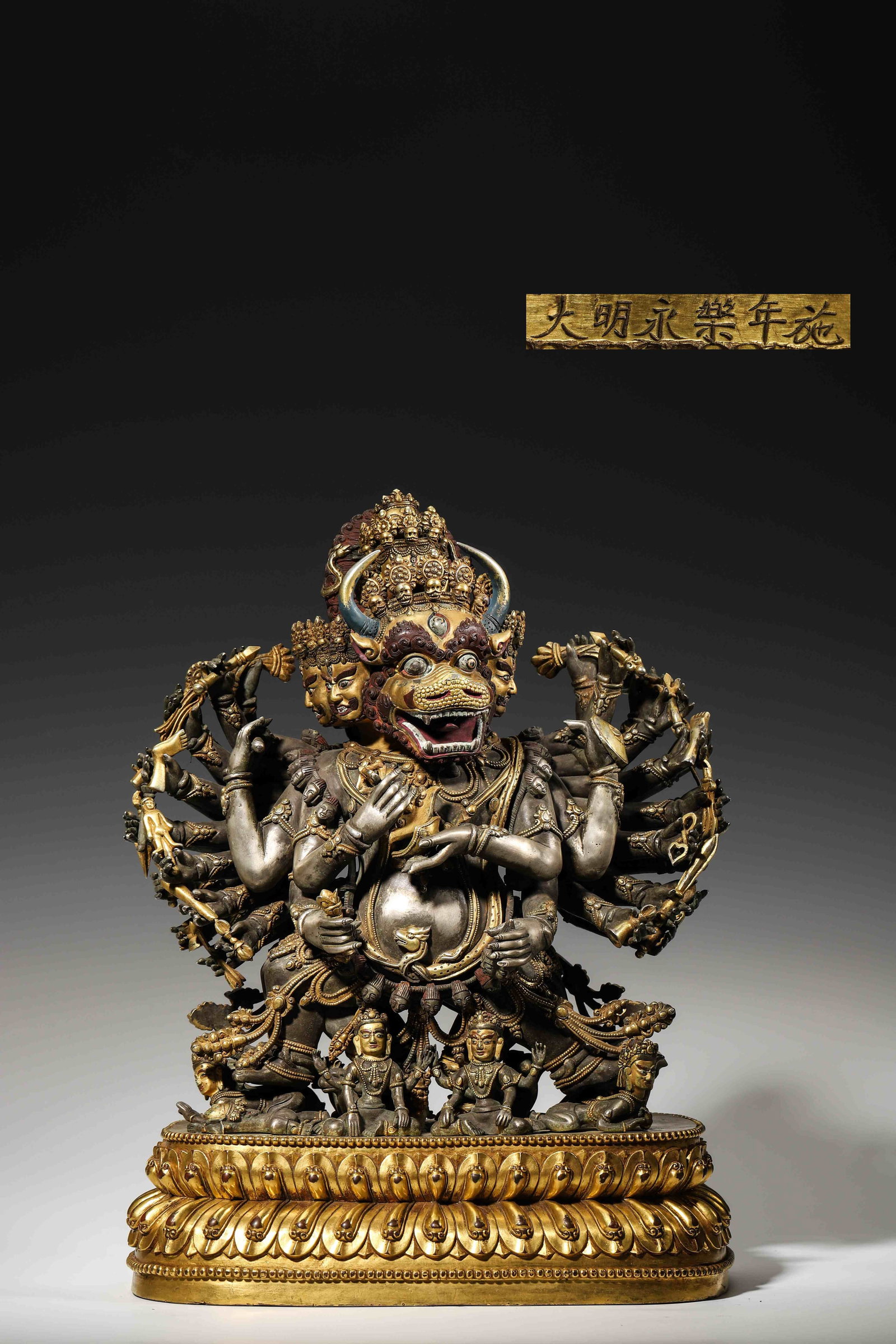 Yongle-Period Ming Copper-Silver Alloy Yamantaka Statue: Copper-silver mixed casting guardian statue. Multi-faced and multi-armed fierce figure on gilded lotus base, inscribed "Yongle of Great Ming", cross-vajra engraved on base interior for Tibetan Buddhis