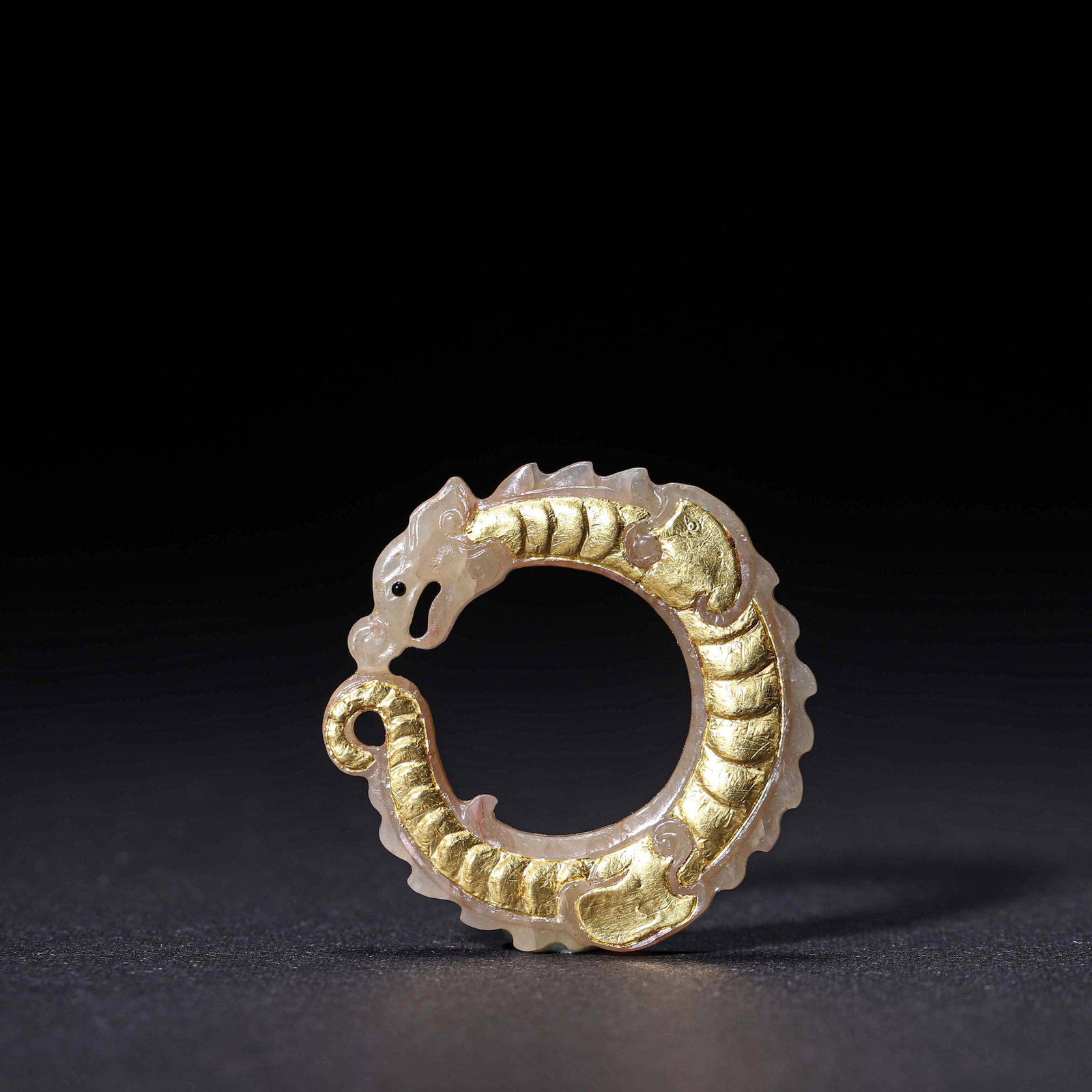 Han Dynasty, White Jade C-Shaped Dragon Pendant With Gold Inlay: Carved from white jade into a C-shaped dragon with gold inlay on its body and distinct scale patterns. It was used as a personal pendant for ornamentation and blessing in ancient times.D3.5cm (1.38 in