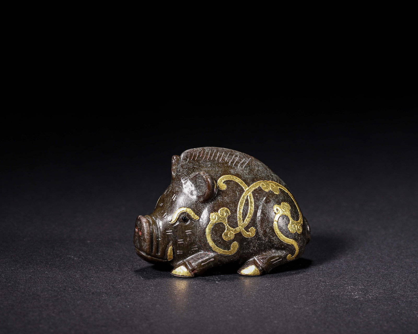 Han Dynasty, Bronze Recumbent Pig Weight With Gold Inlay: This bronze pig is crafted in recumbent posture with plump and smooth body. Gold inlaid cloud scroll patterns decorate its surface, featuring a simple and vivid look. It is an exquisite bronze weight 