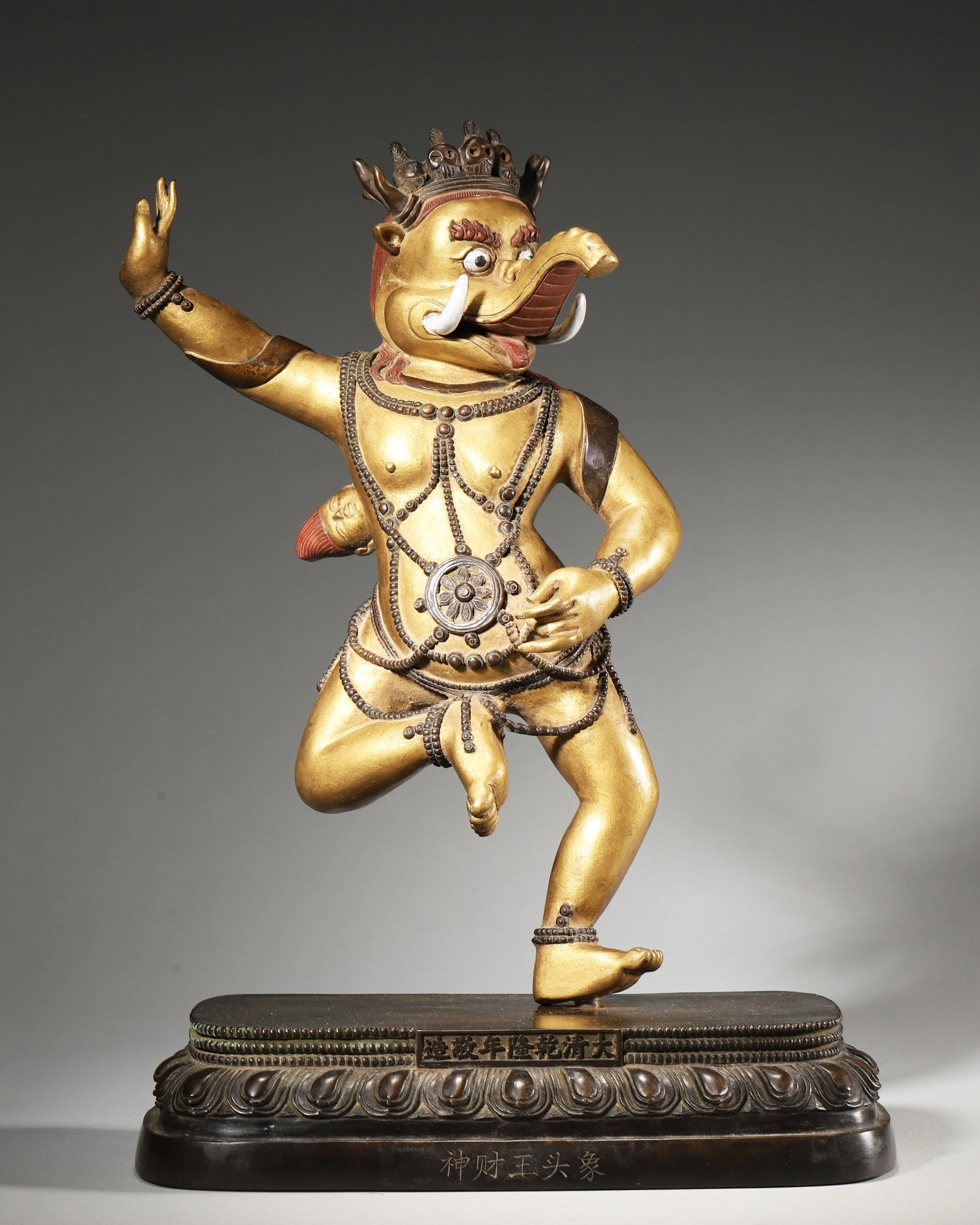 Qing Dynasty Gilt-Bronze Standing Avalokitesvara With Lotus: Qing dynasty Tibetan gilt-bronze standing Avalokitesvara, crowned and ornately adorned, holds lotus, abhaya mudra, inscribed Tibetan texts on base, for shrine worship, partial gilding wear and natural