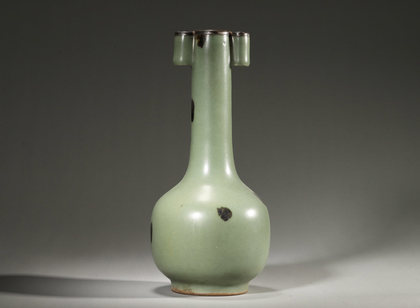 Longquan Celadon Spot-Glazed Arrow Vase,Yuan Dynasty,1271-1368: Long neck with two tubular ears,metal-bound rim,bulbous body and ring foot.Covered with celadon glaze decorated with dark brown spots.Foot rim reveals reddish-brown biscuit.D 12cm (4.72 in); H 27cm