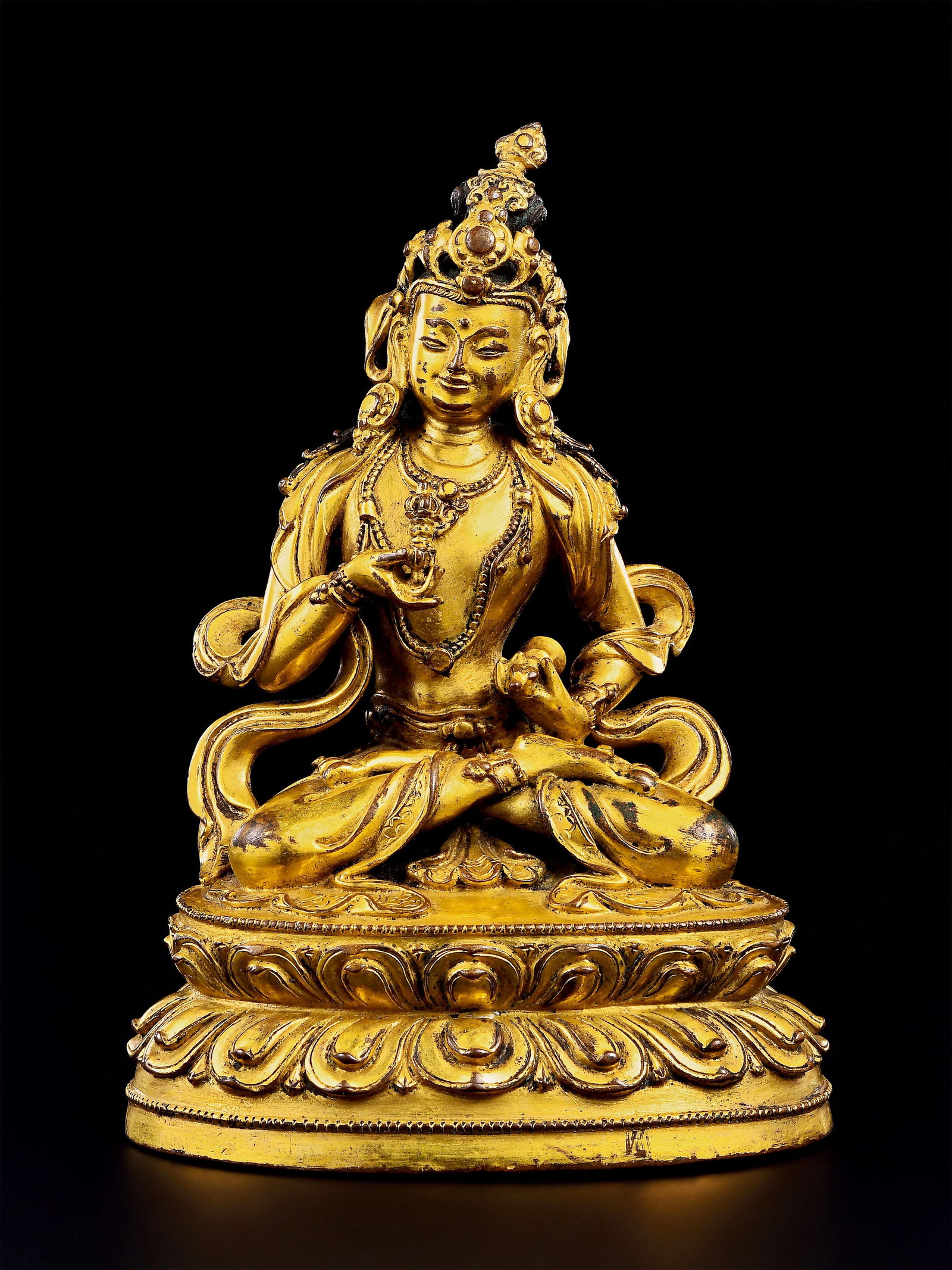 15Th Century, Gilt-Bronze Seated Statue Of Vajrasattva: Seated in full lotus position on double-petal lotus base. Adorned with crown and beaded ornaments, holding vajra and ghanta. Well-modelled lotus petals, mellow gilt surface, fine Tibetan-Buddhist scul