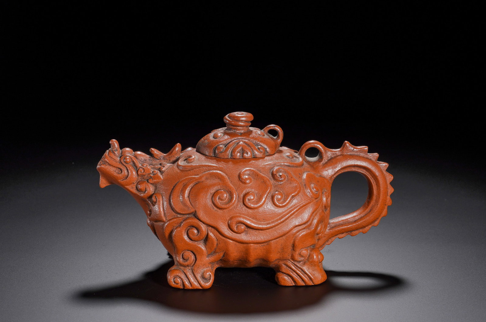Qing Dynasty Chen Mingyuan Red Clay Auspicious Beast Cloud Pattern Purple Clay Teapot: Height:11cm(4.33in), Width:19cm(7.48in), Weight:460g(1.014lb)Vermilion-Clay Teapot in Mythical-Beast Form with Cloud-scroll Decoration, Qing Dynasty. The whole vessel is shaped as a mythical beast: th