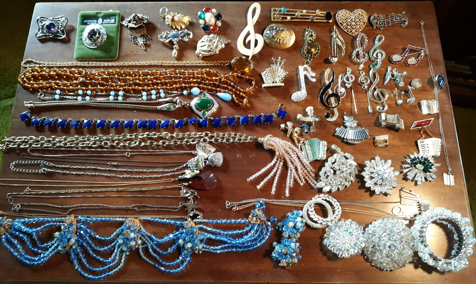 Assorted Costume Jewelry: Assorted costume jewelry including necklaces, pins and bracelet