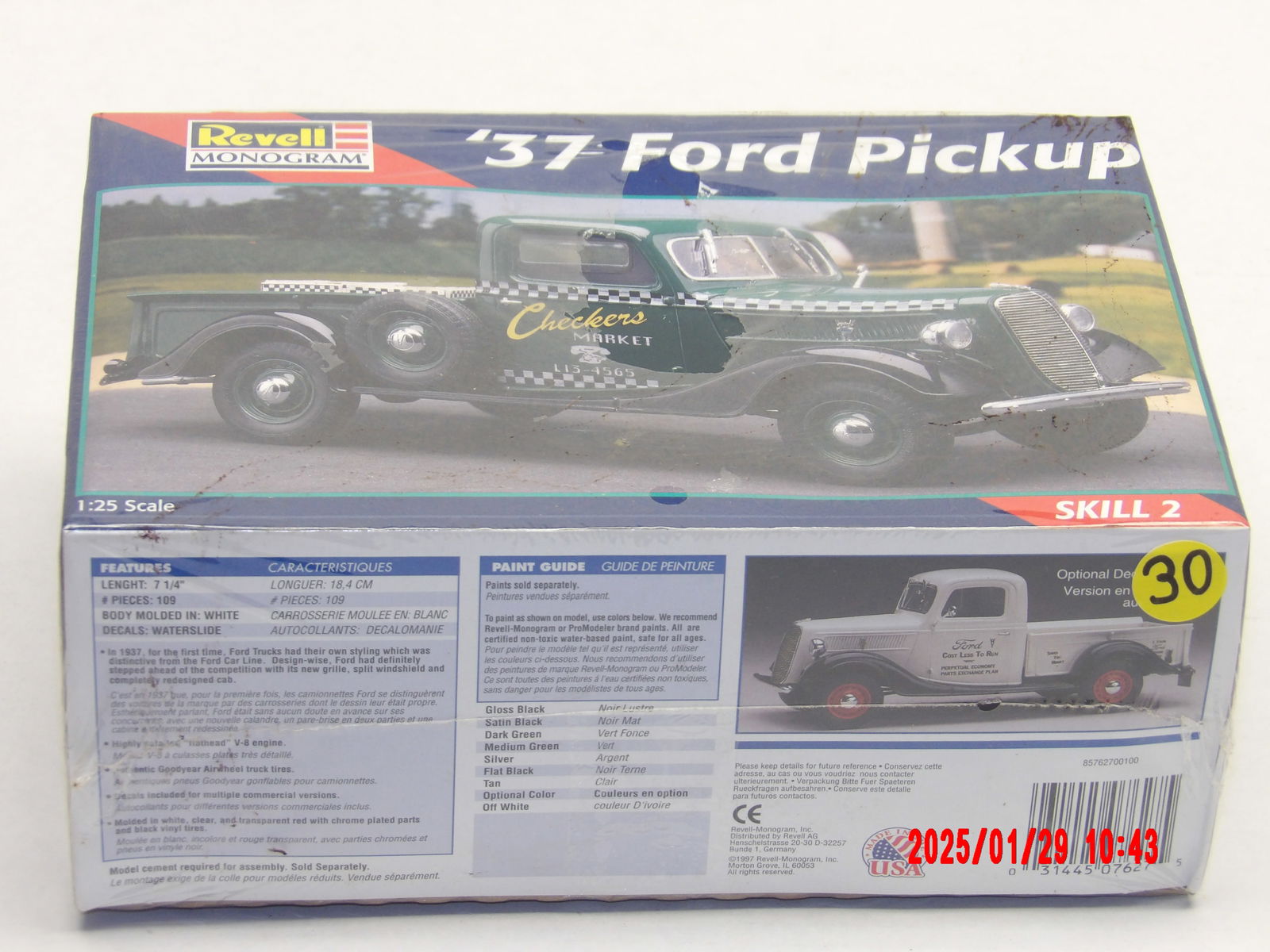 Revell Monogram 1937 Ford Pickup truck 1/25 scale model kit: This Revell Monogram '37 Ford Pickup model kit is a vintage-style plastic model, allowing for detailed assembly. The "Checkers Market" design and checkerboard stripe suggest a customized or themed ver