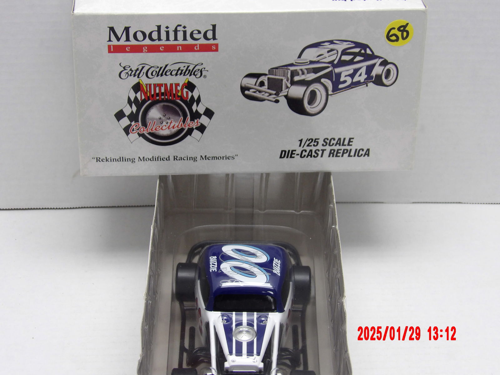 Autographed 1/25 Scale Die-Cast Modified Legends Race Car - #00 "Buzzie" Tribute Edition: This 1/25 scale die-cast modified stock car is a part of the Modified Legends Series by Ertl Collectibles / Nutmeg Collectibles. The name "Buzzie" is inscribed on both sides of the number, signifying