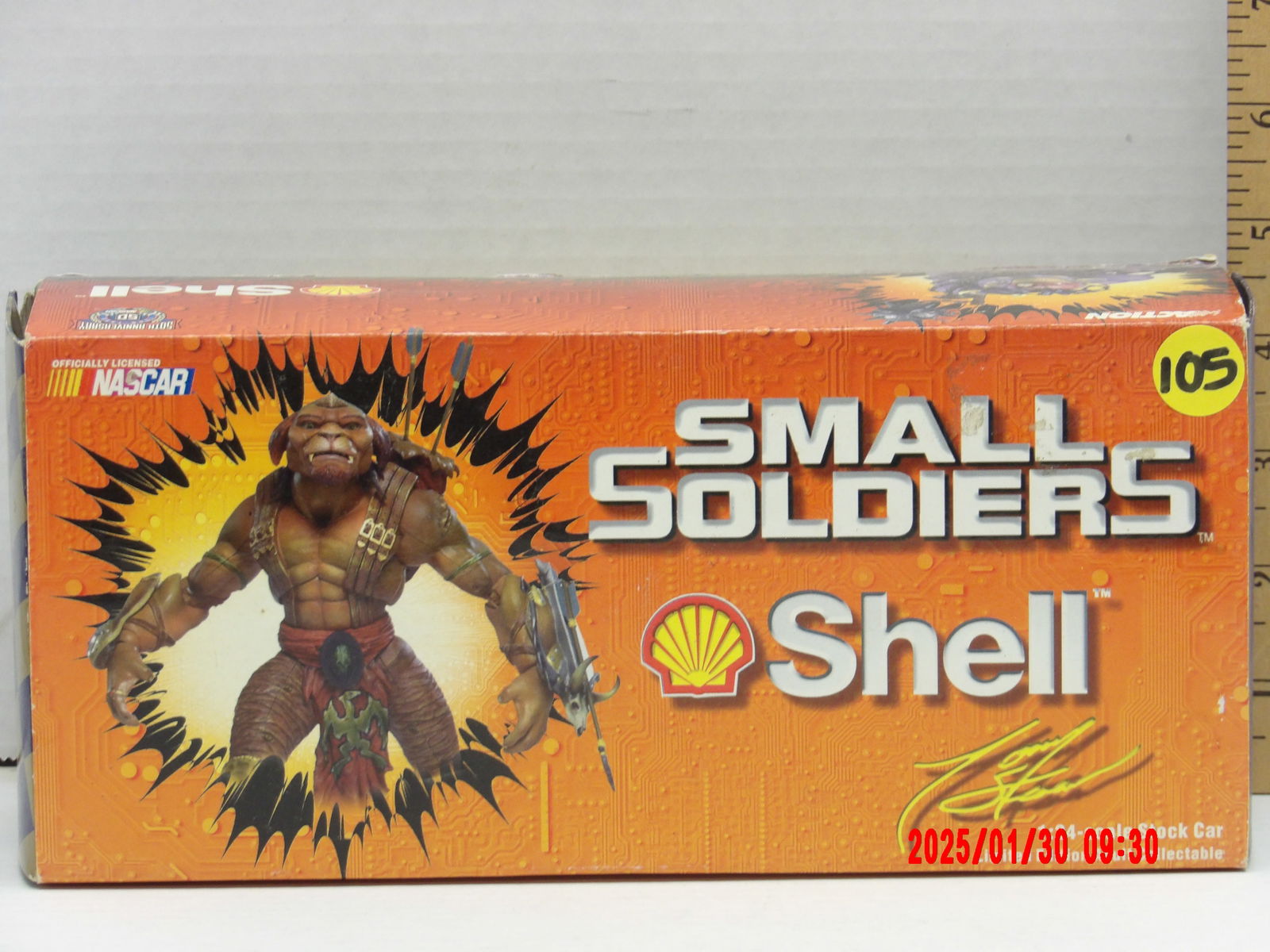 Small Soldiers NASCAR Shell Collectible Die-Cast Car: This is a Small Soldiers-themed NASCAR collectible die-cast car, officially licensed by NASCAR, Shell, and Action Racing Collectibles. The packaging prominently features Brick Bazooka, one of the Comm