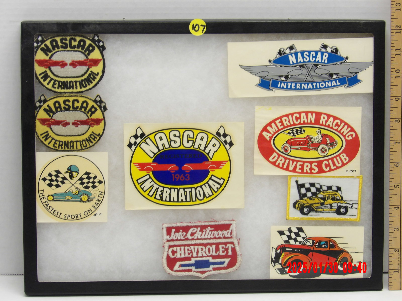 Vintage NASCAR & American Racing Patches and Decals Collection – NASCAR International & Racing: This framed collection of vintage racing patches, decals, and stickers celebrates the rich history of NASCAR International and other American racing organizations. The display contains a mix of embroi