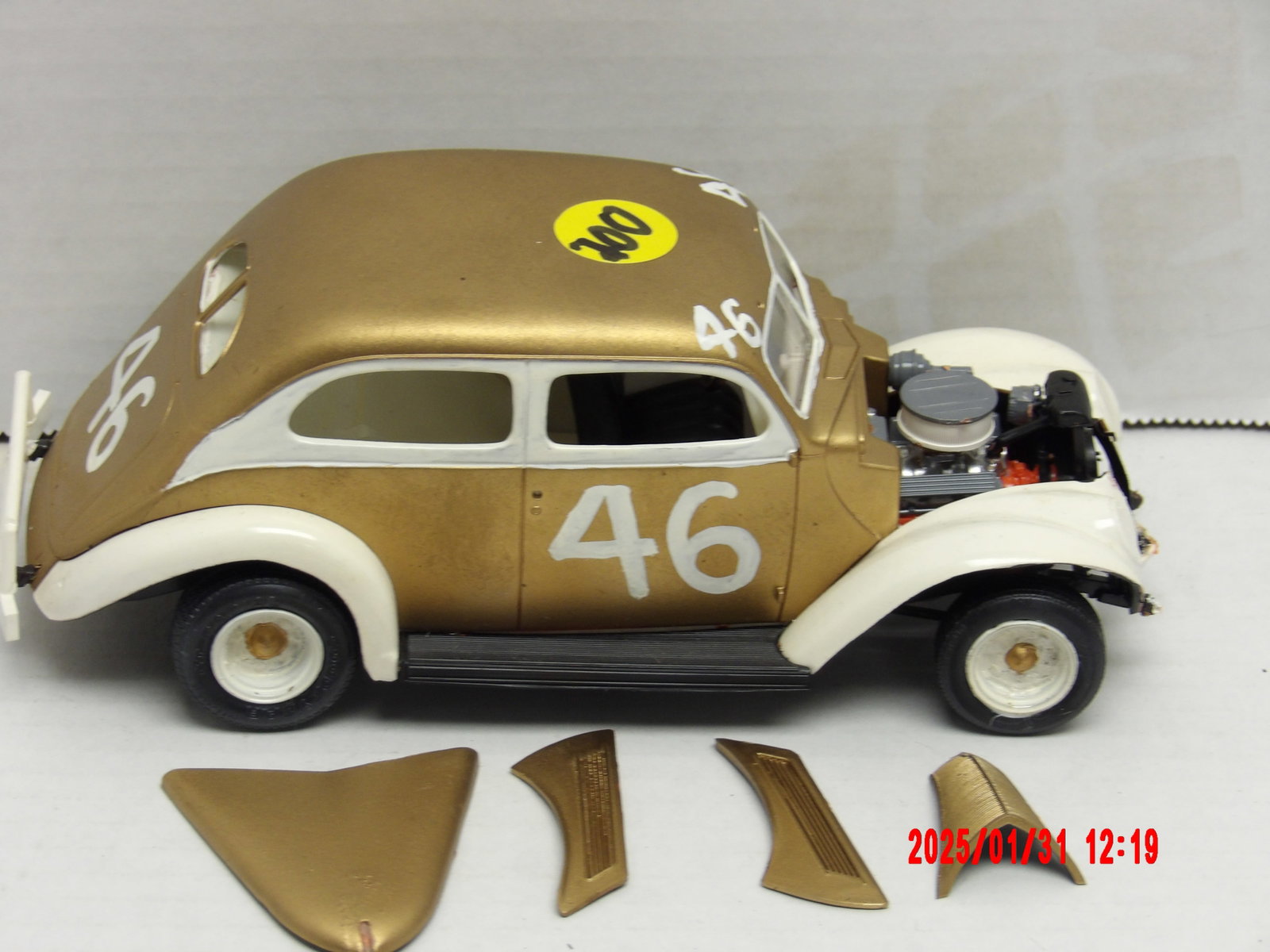 Vintage Al Tasnady Stock Car Model - Gold & White #46 with Exposed Engine: This lot features a classic stock car model driven by Al Tasnady, painted in an elegant gold and white color scheme, bearing the number 46 on its doors, roof, and rear. The model represents a vintage 