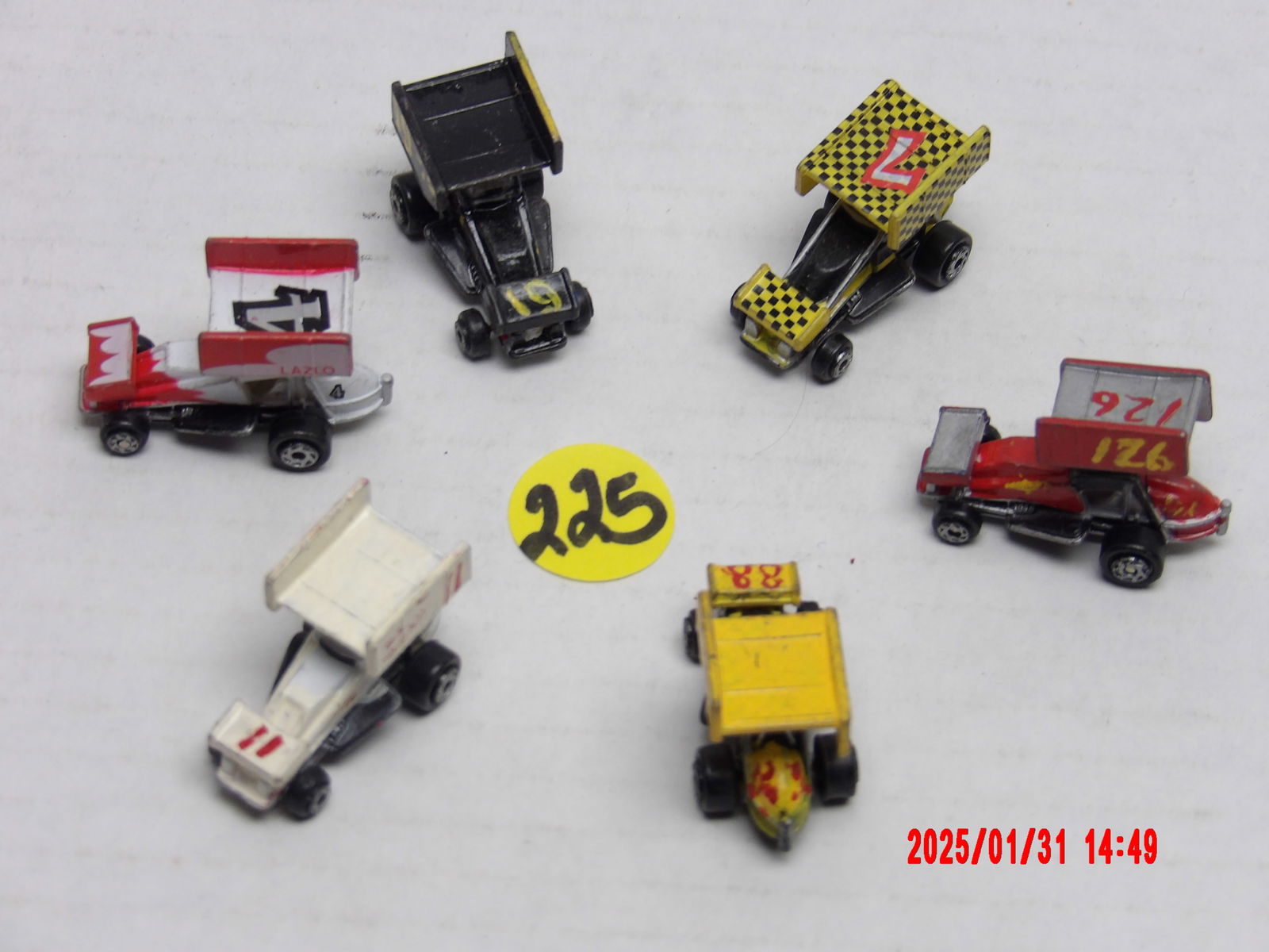 Vintage Miniature Sprint Car Model Collection: This lot features a collection of six miniature sprint car models, each uniquely designed with customized paint schemes and numbers. These die-cast or plastic models replicate the classic winged sprin