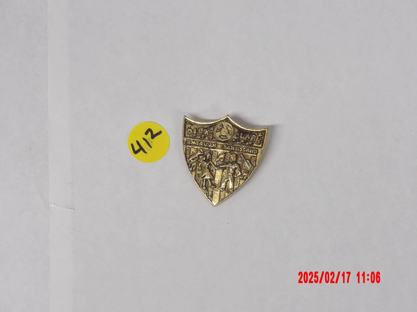 Vintage Dick Clark's American Bandstand Commemorative Pin: This lot features a vintage commemorative pin related to Dick Clark’s American Bandstand, a legendary television show that played a pivotal role in the history of rock and roll and pop music. The pi