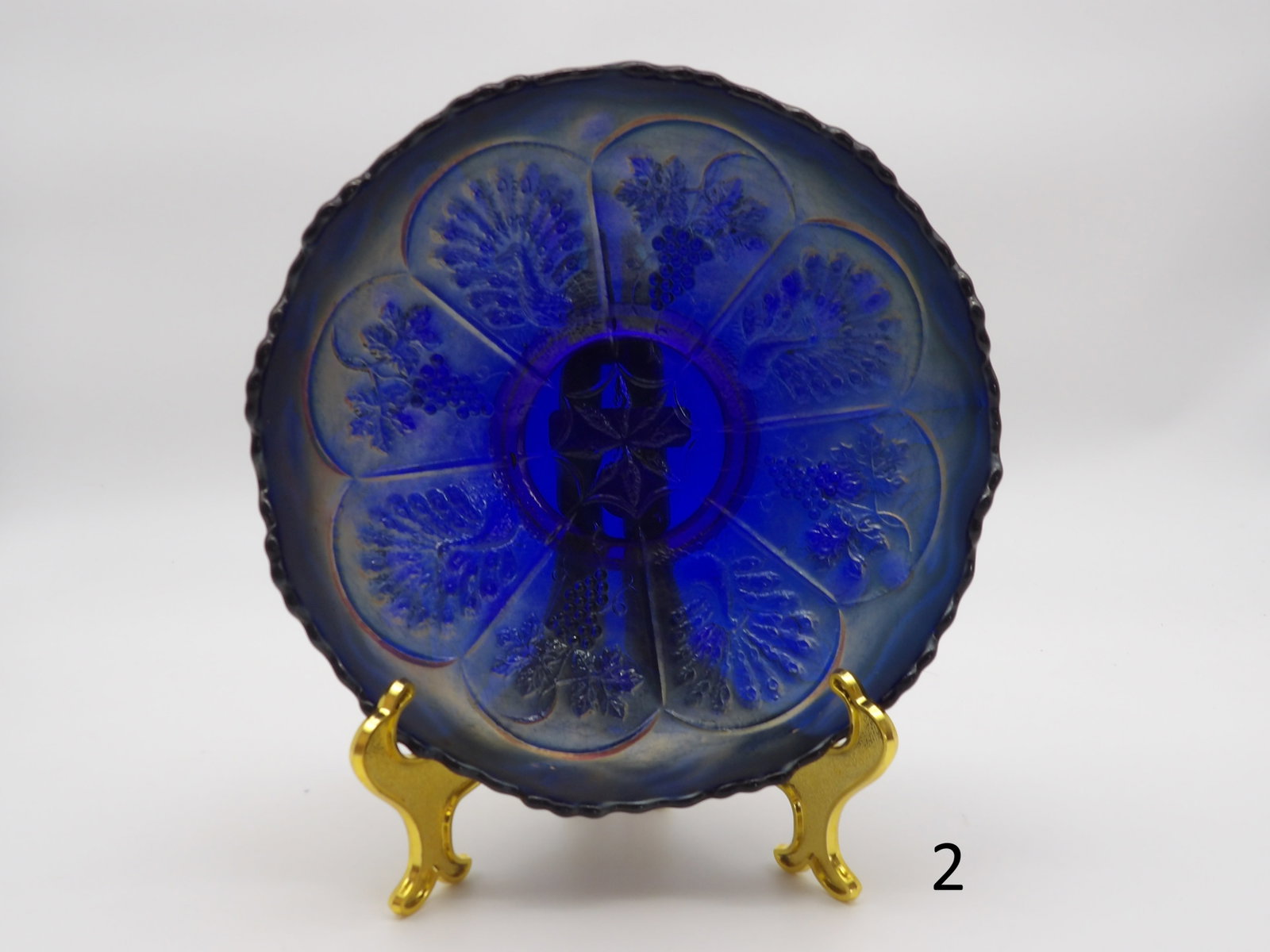 Vintage Peacock Cobalt Blue Glass Bowl by Fenton Art Glassware: Iridescent scalloped-edge bowl with embossed peacock and grapevine design. The finish reflects shades of blue, purple, and gold when light hits the surface. Excellent condition, no visible cracks or c