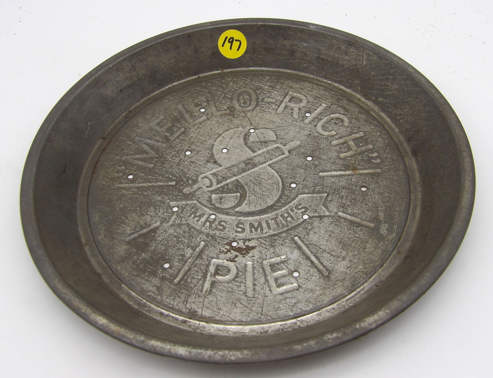 VINTAGE MRS. SMITH’S MELLO-RICH PIE TIN: This vintage “Mrs. Smith’s Pie Company” tin features the "Mello-Rich" brand name and a logo of a rolling pin inside a large letter "S”. It is highly collectible, often as home and kitc