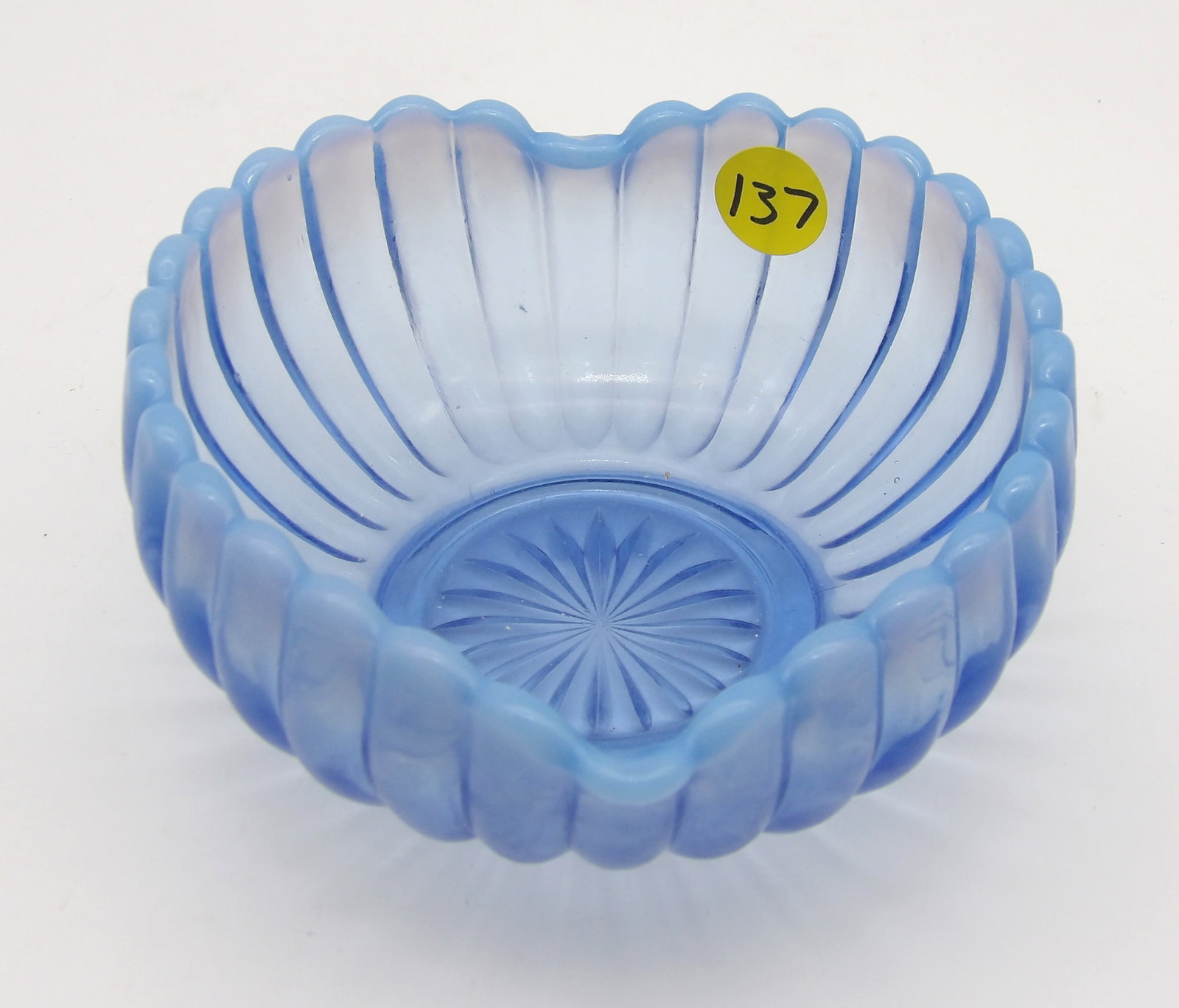 PERIWINKLE BLUE OPALESCENT RIBBED HEART-SHAPED BOWL BY FENTON ART GLASS: This heart-shaped bowl with a ribbed pattern and opalescent rim is very collectible to those interested in vintage glassware.