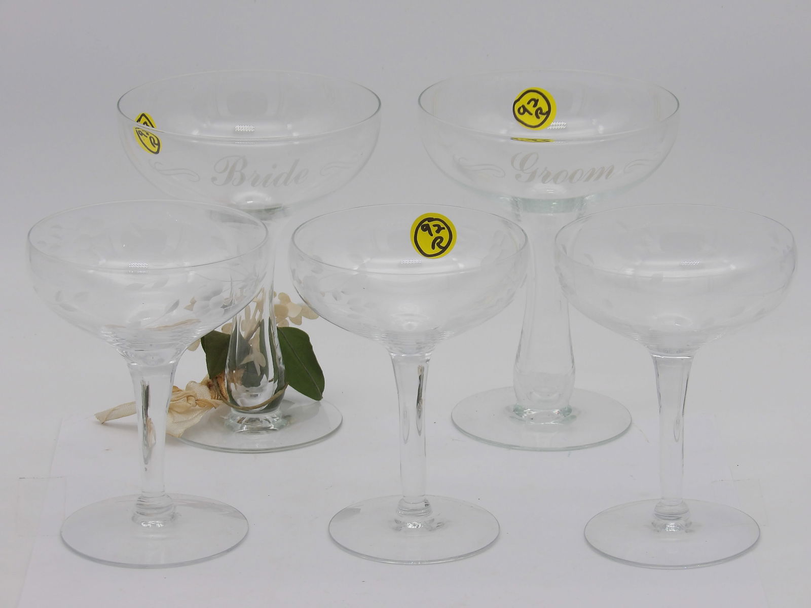 BRIDE & GROOM HOLLOW STEM TOASTING GLASSES AND CHAMPAGNE GLASSES: This set includes 2 hollow-stem champagne “Bride & Groom” toasting glasses and 3 vintage etched champagne coupe glasses.