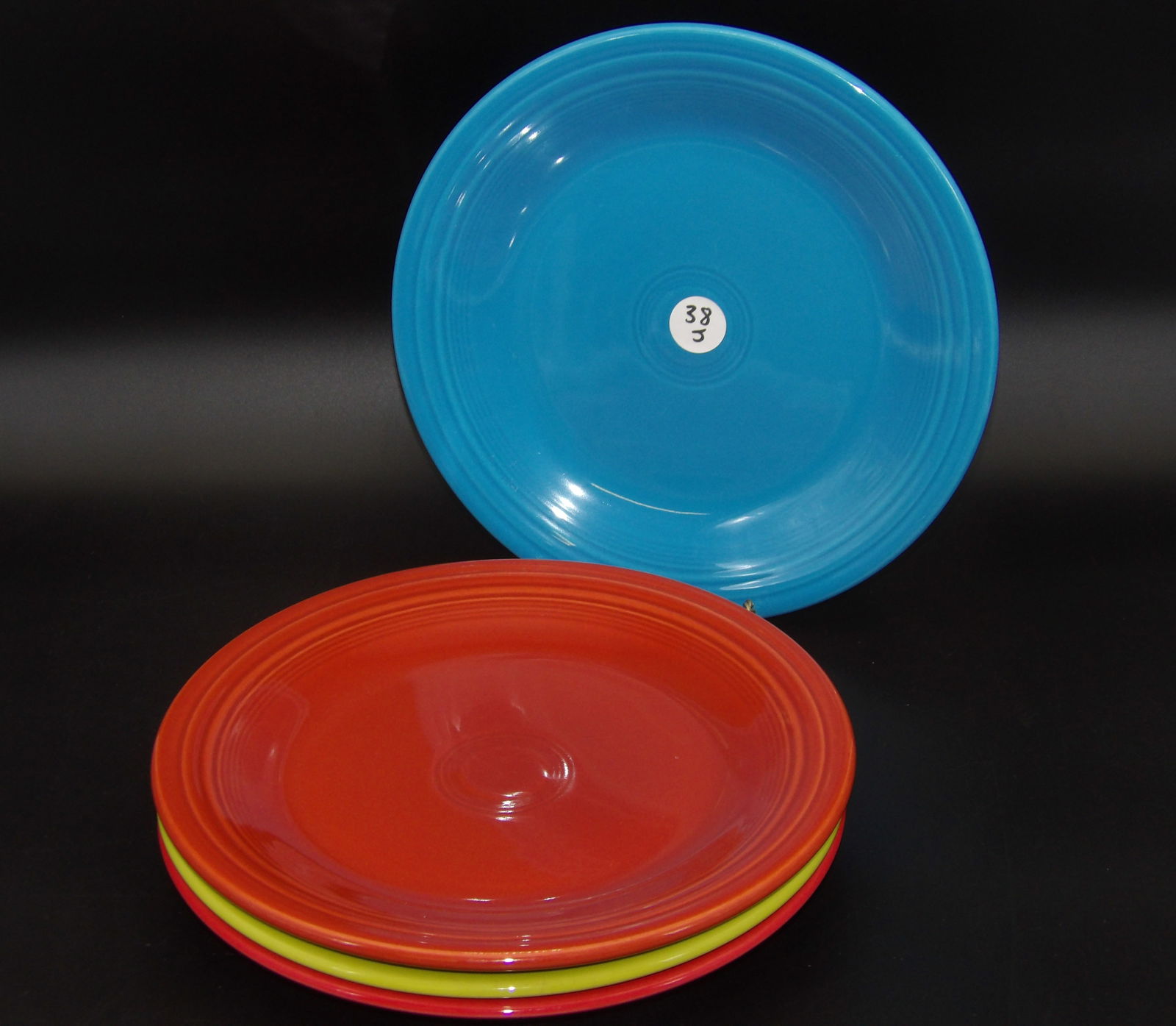 Fiesta Dinner Plates (4): This lot of 4 Fiestaware dinner plates comes in the Lemongrass, Persimmon, Peacock, and Scarlet glazes.Measures:10.5"