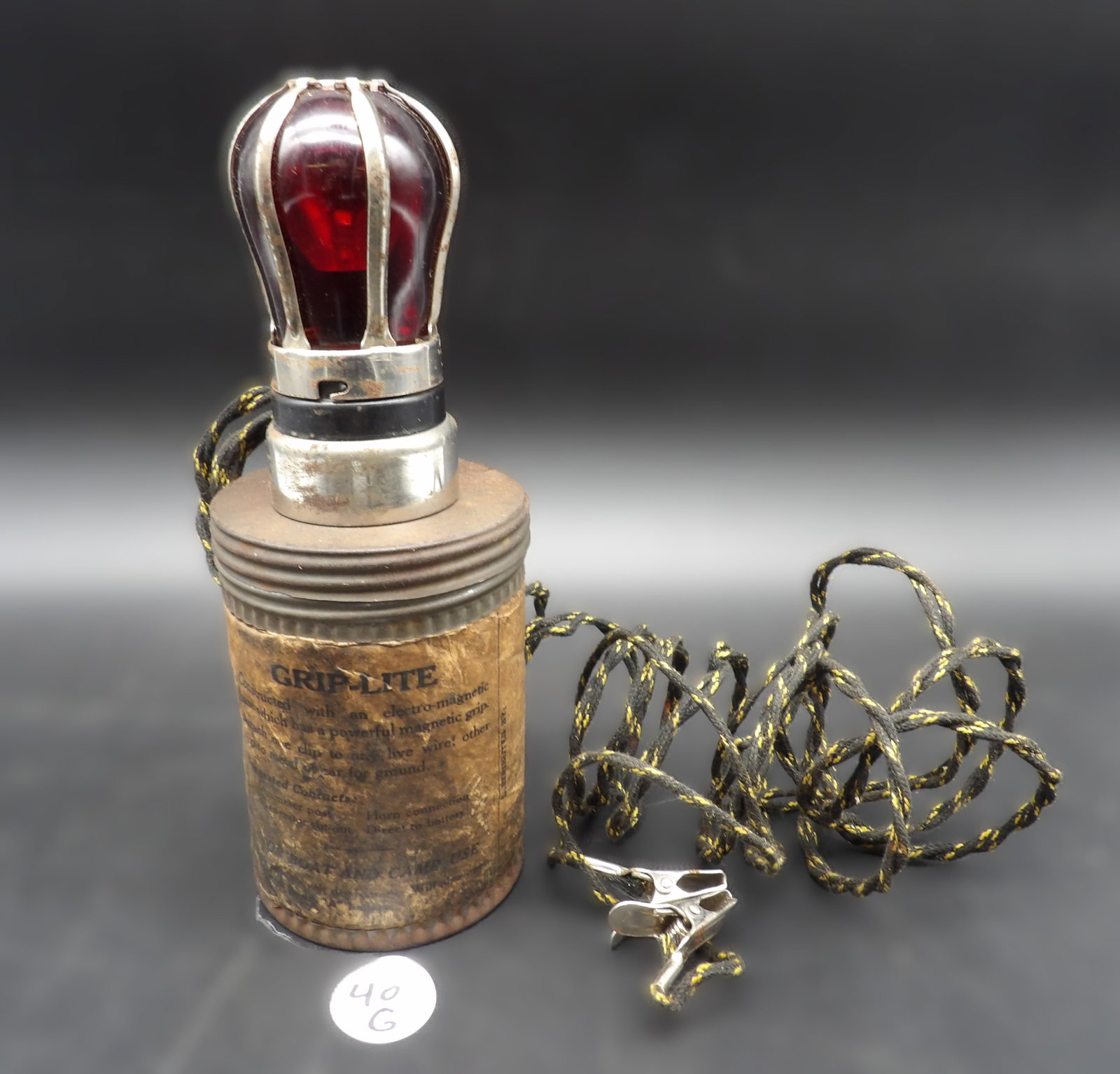 Grip-Lite In Box: This vintage Grip-Lite (by Magno-Sales) is made to connect to a car's battery and is magnetically attached to the car to temporarily replace a busted light. Light is in great shape, though the origina