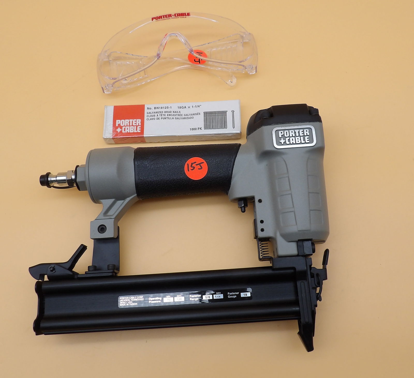 Porter-Cable Brad Nailer: This Porter-Cable Brad Nailer (Model BN125) is new in the box and includes lube oil, safety glasses, brad nails, and owner's manual. Includes carry case. Measures: 15.5" x 14.5" x 3"