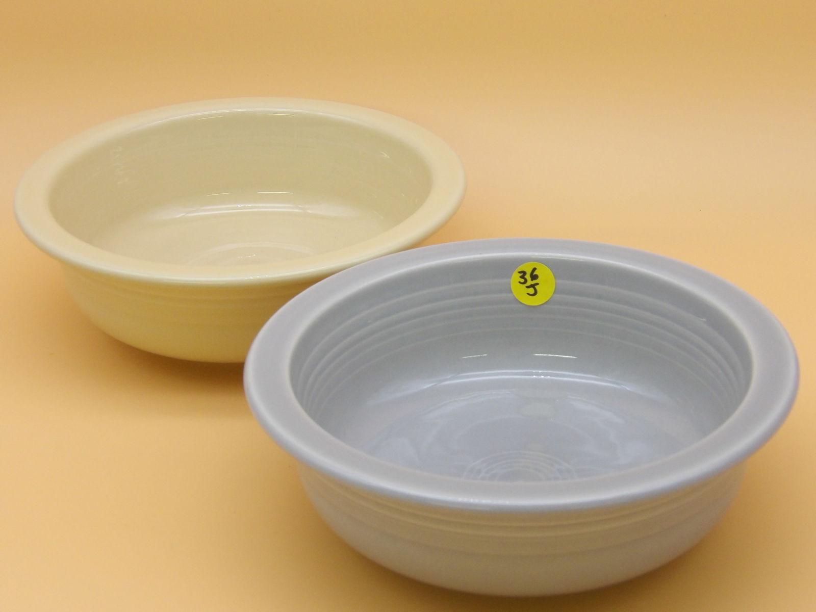 Fiestaware Serving Bowls (2): This pair of Fiestaware serving bowls comes in Custard and Pearl Grey glazes. Modern era. Measures: 8.5" x 3" each