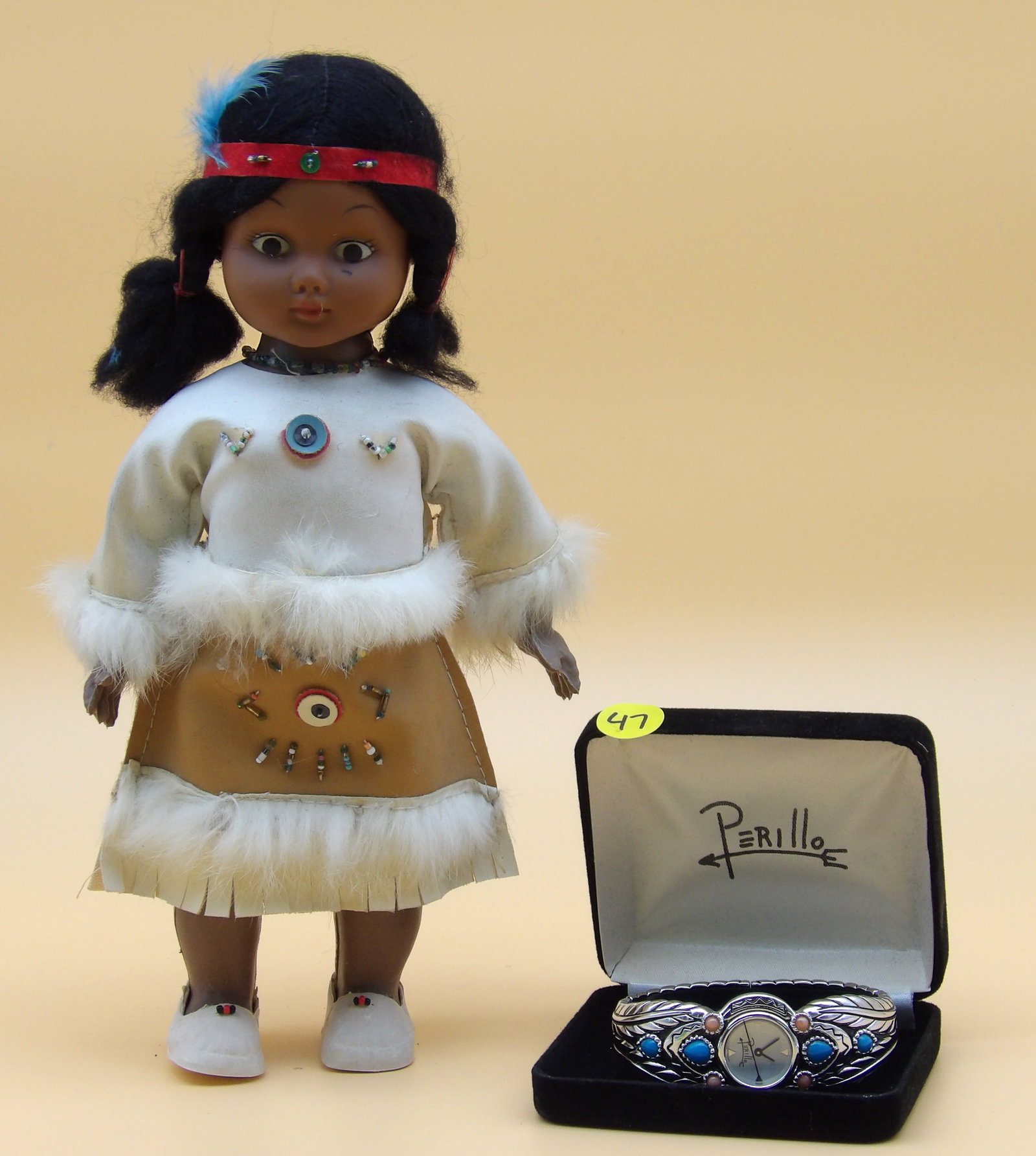 Southwestern Perillo Native Cuff Watch and Native American Doll: This lot includes a Southwestern Native Perillo cuff watch featureds turqouis and coral (comes in case), and a Native American plastic doll. Measures: 4" x 4" x 1.5" and 11" x 6"