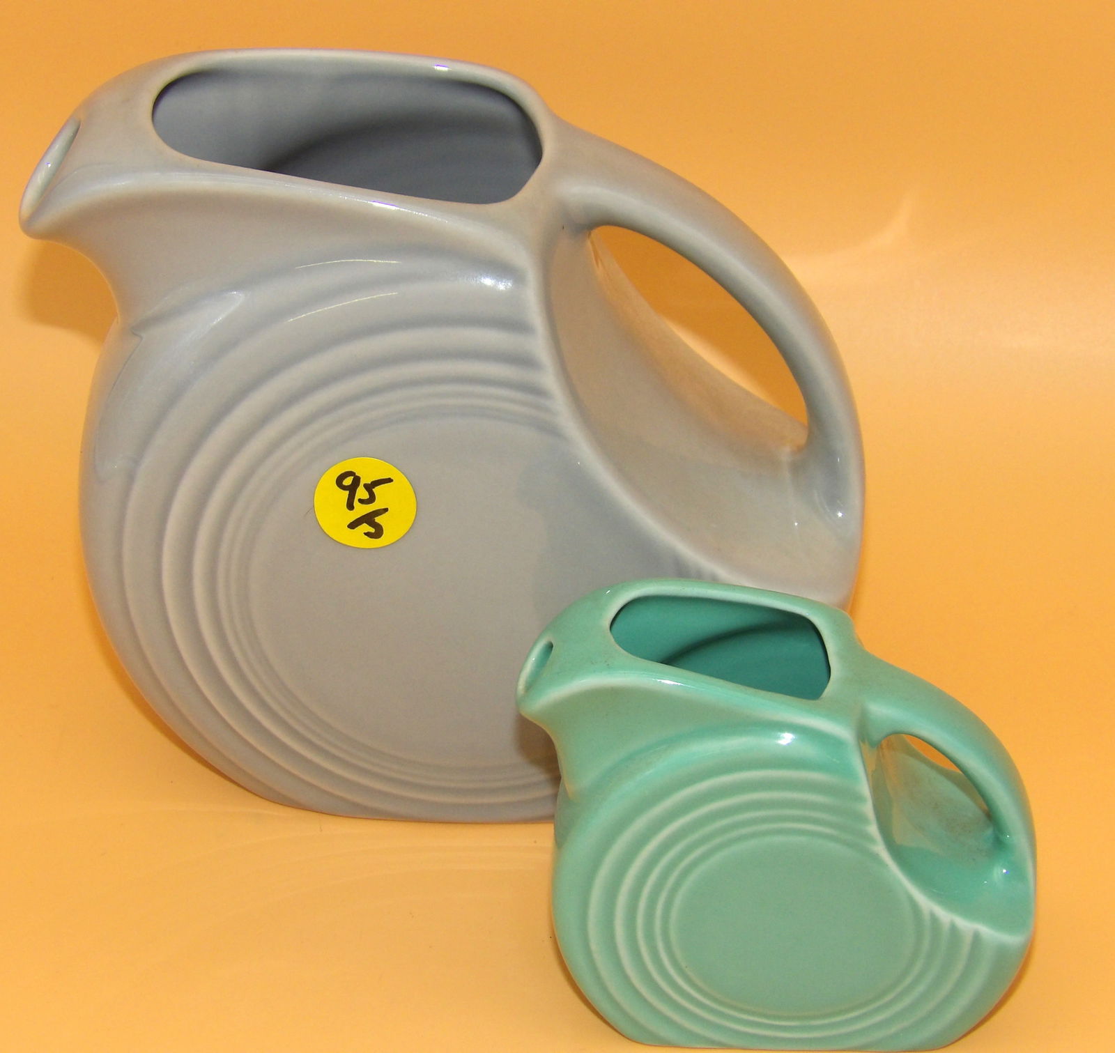 Fiestaware Disc Pitcher & Mini Disc Pitcher: This pair of modern-era Fiestaware disc pitchers includes both regular and miniature sizes. They come in Pearl Gray & retired Sea Mist Green glazes. Measures: 6" x 7" x 2.5" & 3.5" x 4" x 1.5"