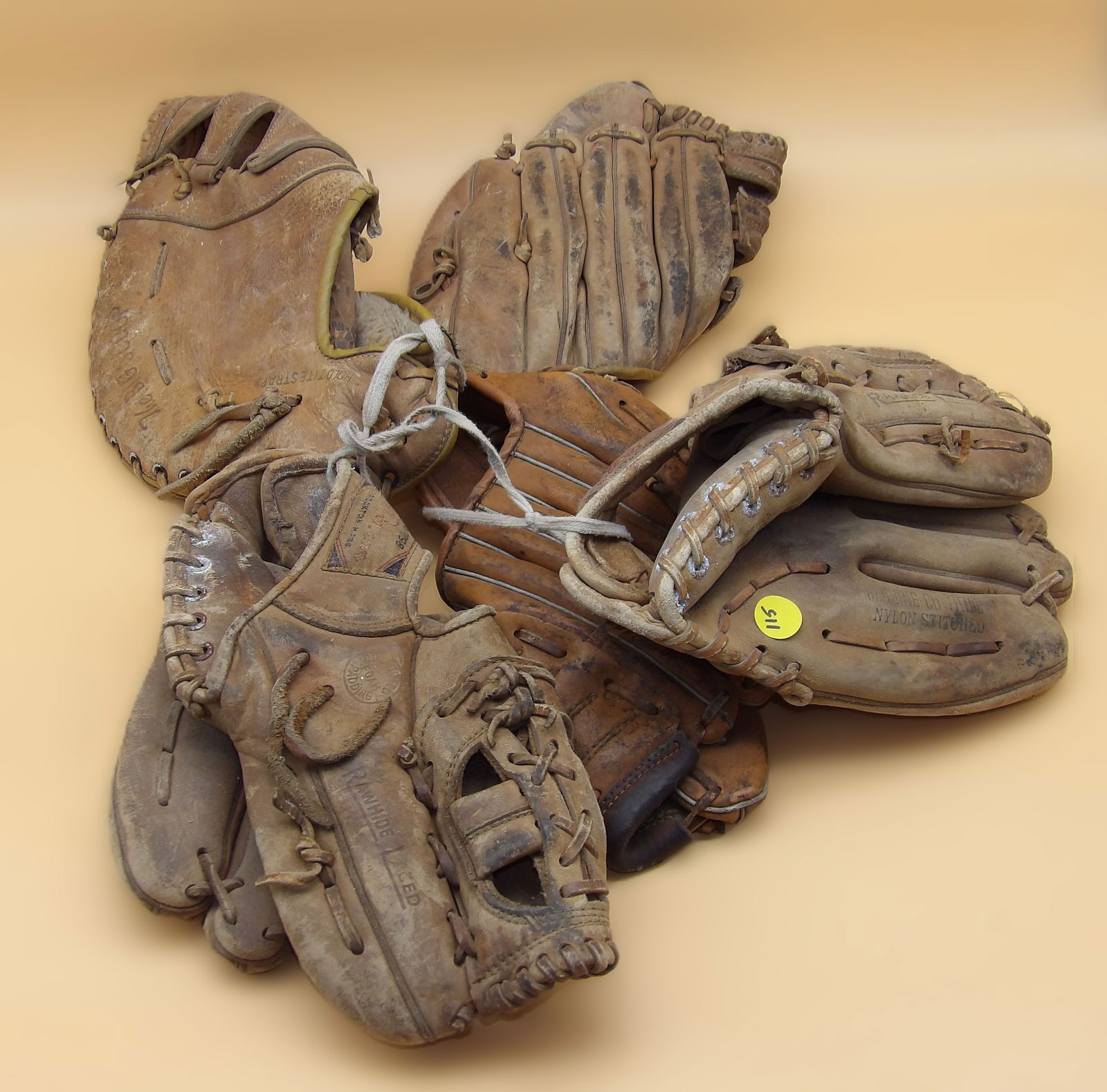 5 Vintage Baseball Gloves: Catch this lot of 5 vintage leather baseball gloves. Brands include Wilson, All Pro, Stall & Dean. Measures roughly: 9" x 9" each.