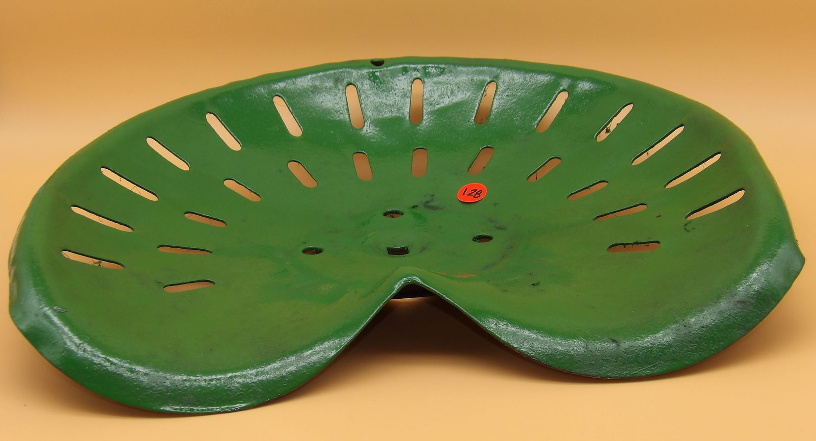 Vintage Cast Iron Tractor Seat: This vintage cast iron tractor seat is painted a vibrant John Deer green. Measures 16.5" x 14"
