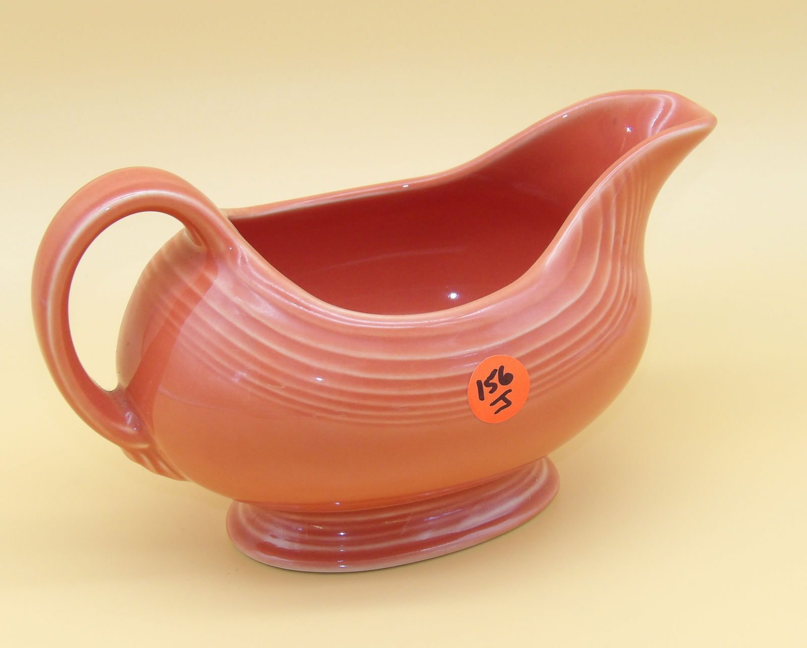 Fiesta Gravy Sauceboat: This modern-era Fiesta gravy sauceboat comes in Persimmon glaze. Measures 5" x 8" x 4"